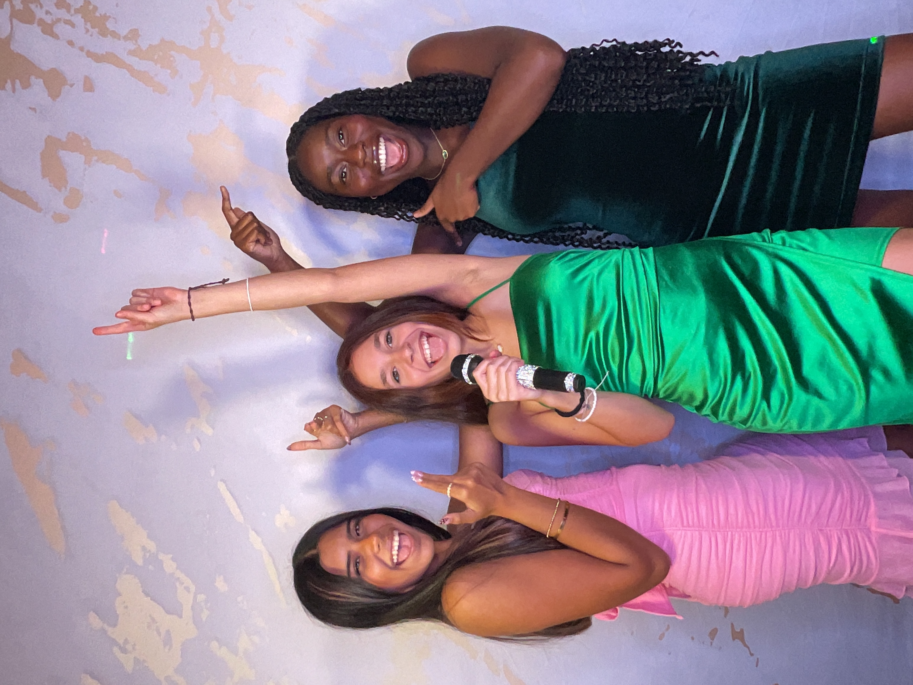 Teens having fun with a photo booth at a Sweet 16 birthday party.