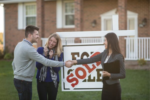 man shaking hands with a real estate girl man shaking hands with a real estate girl
