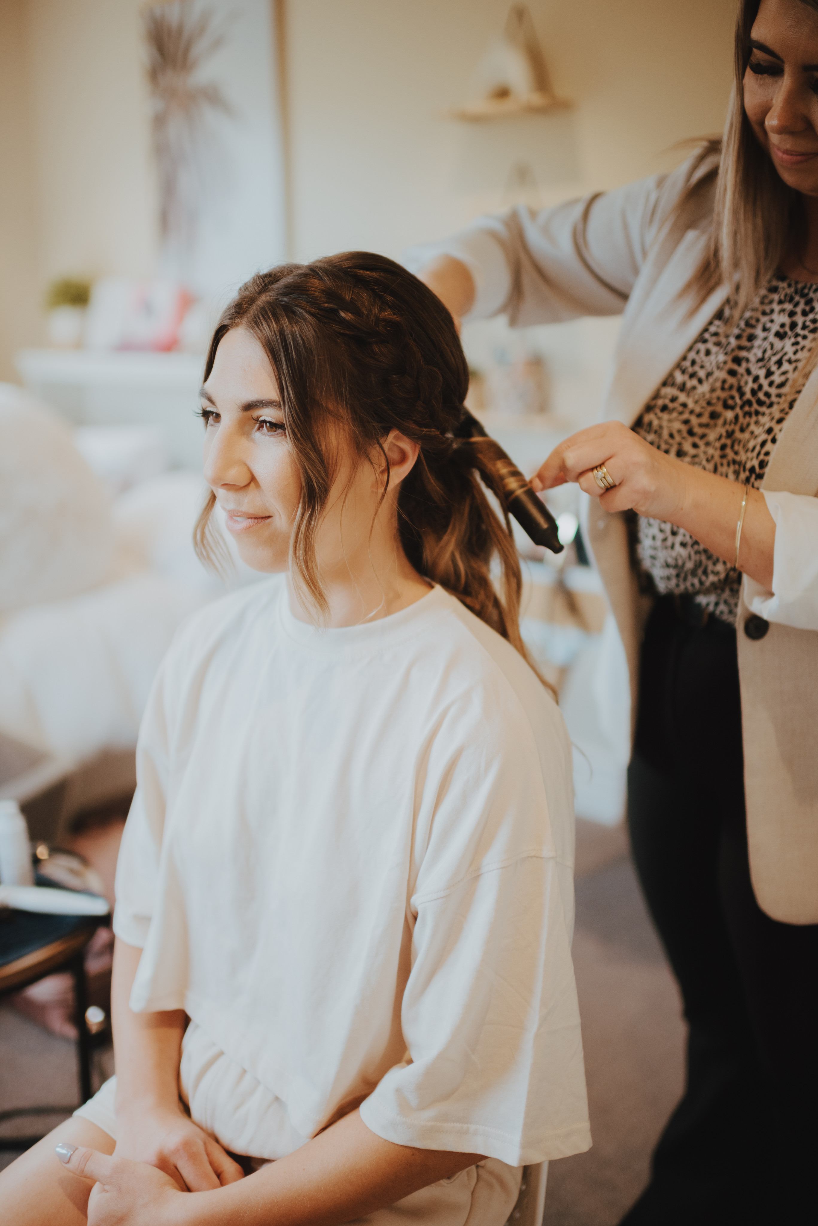 bride having her hair done for wedding