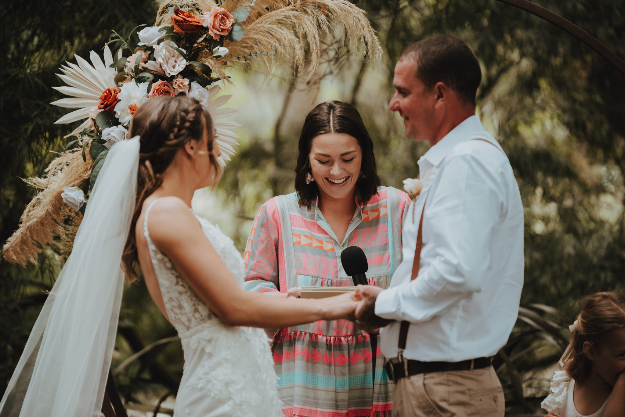 wedding ceremony with couple holding hands