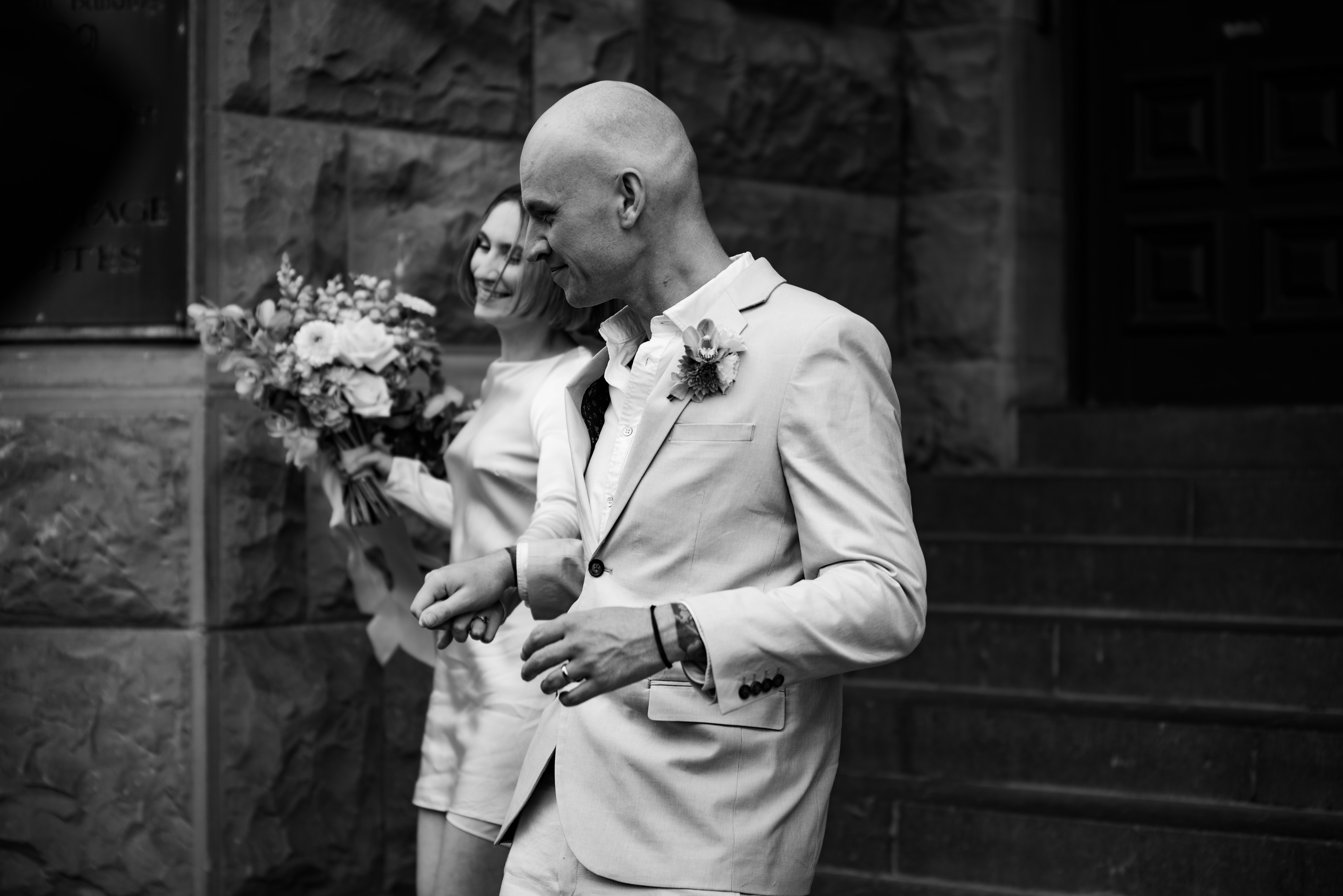 couple running down the stairs after getting married