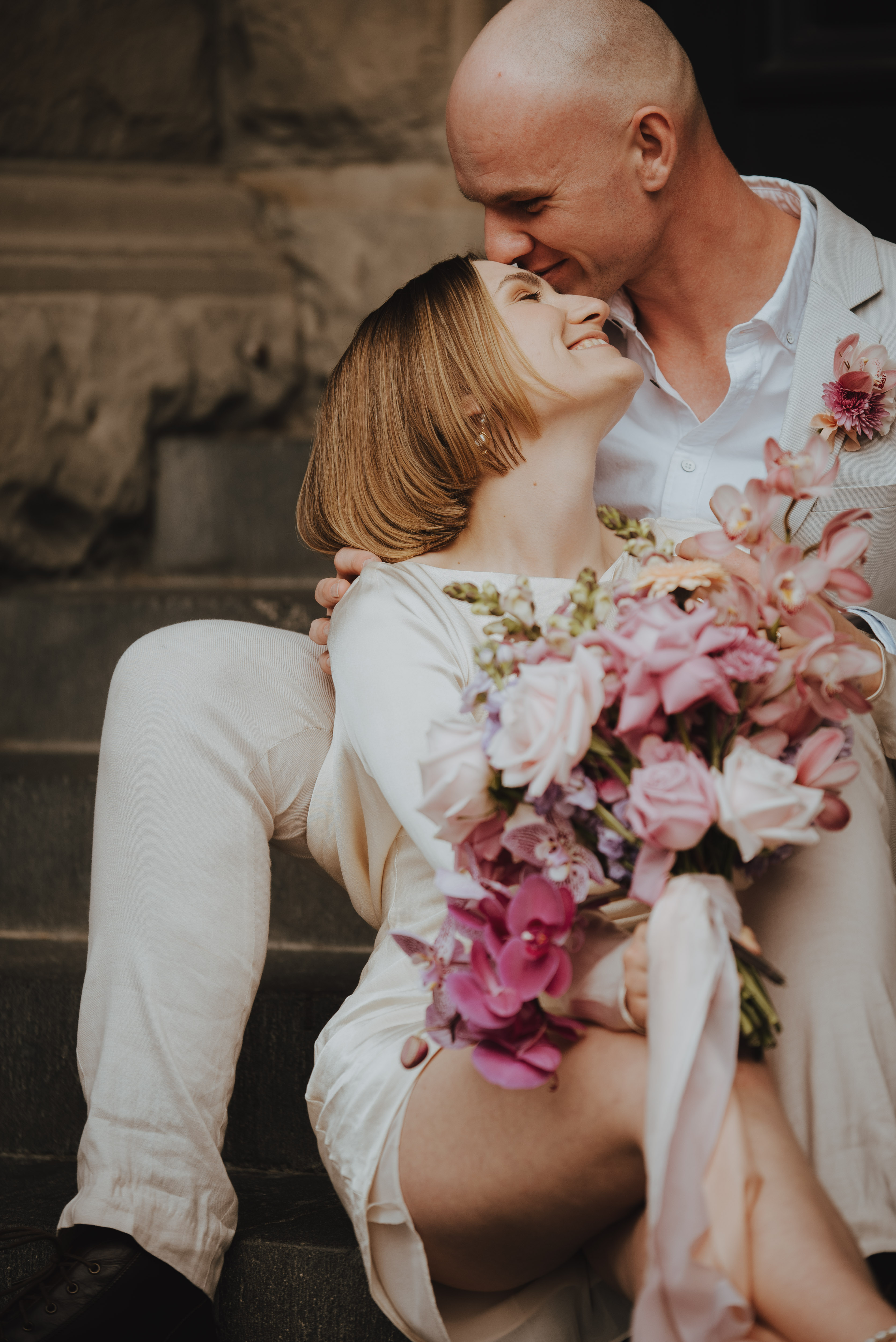 couple sitting on stairs kissing