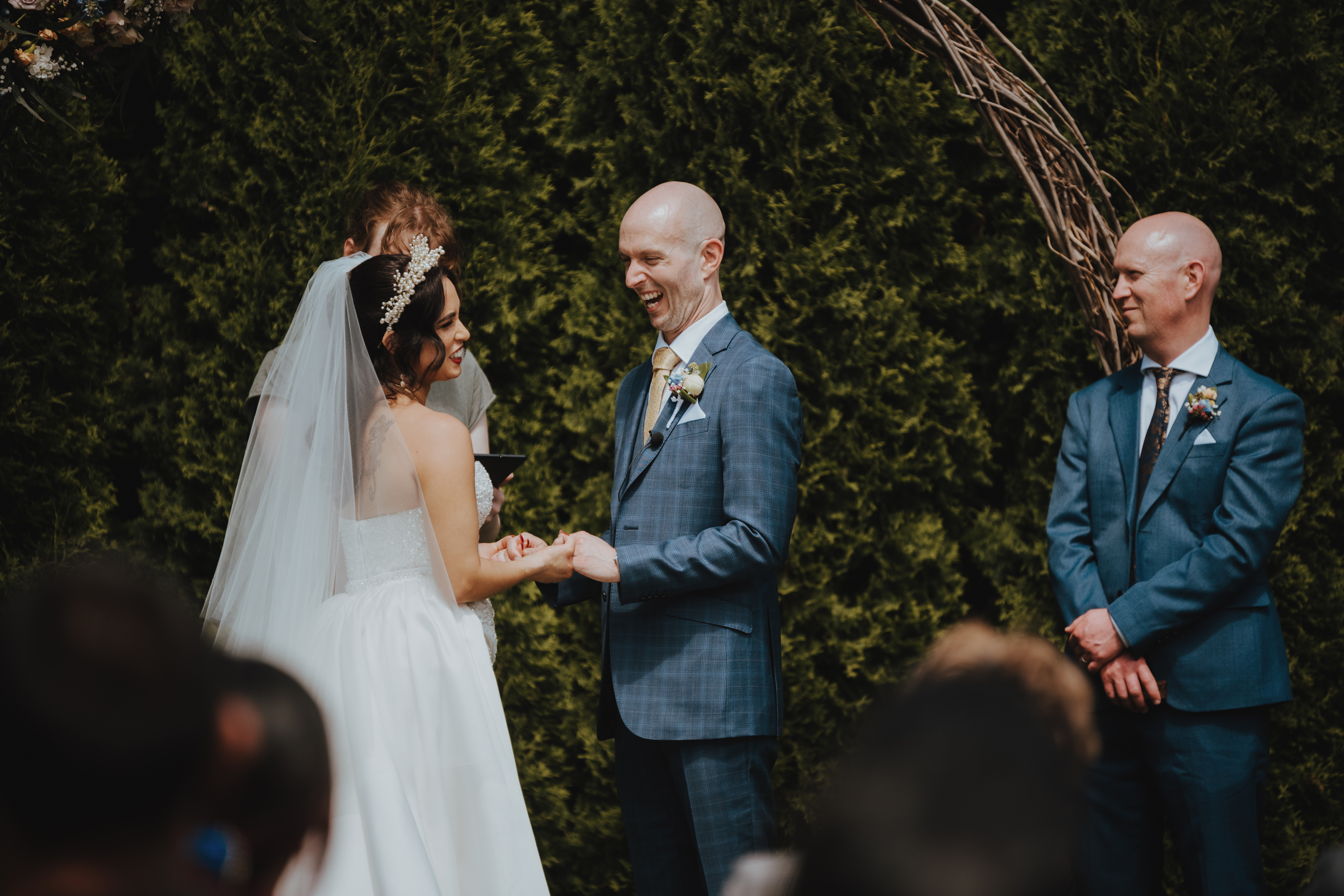 groom smiling and laughing with his bride