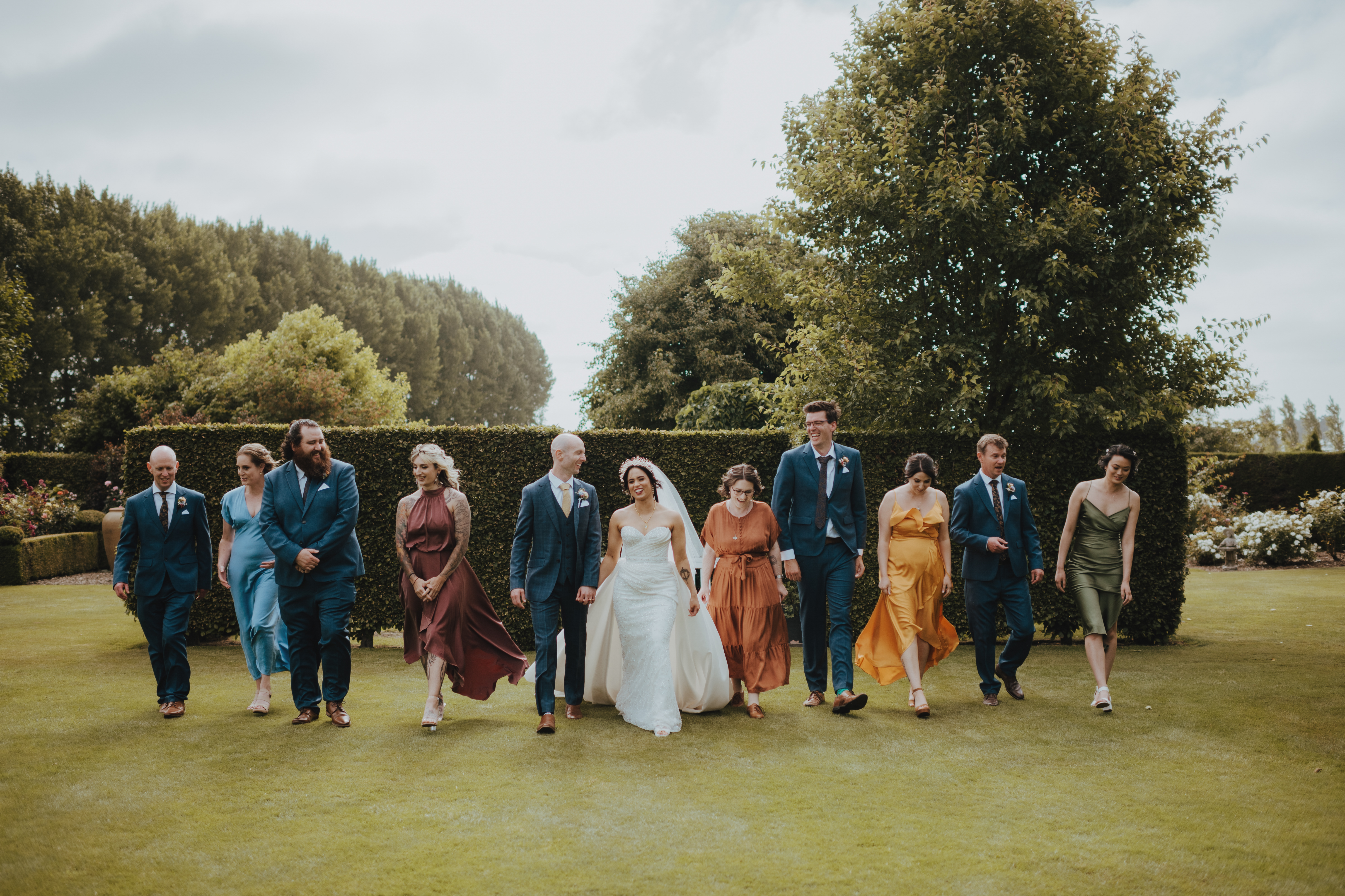 bridal party walking through the garden together