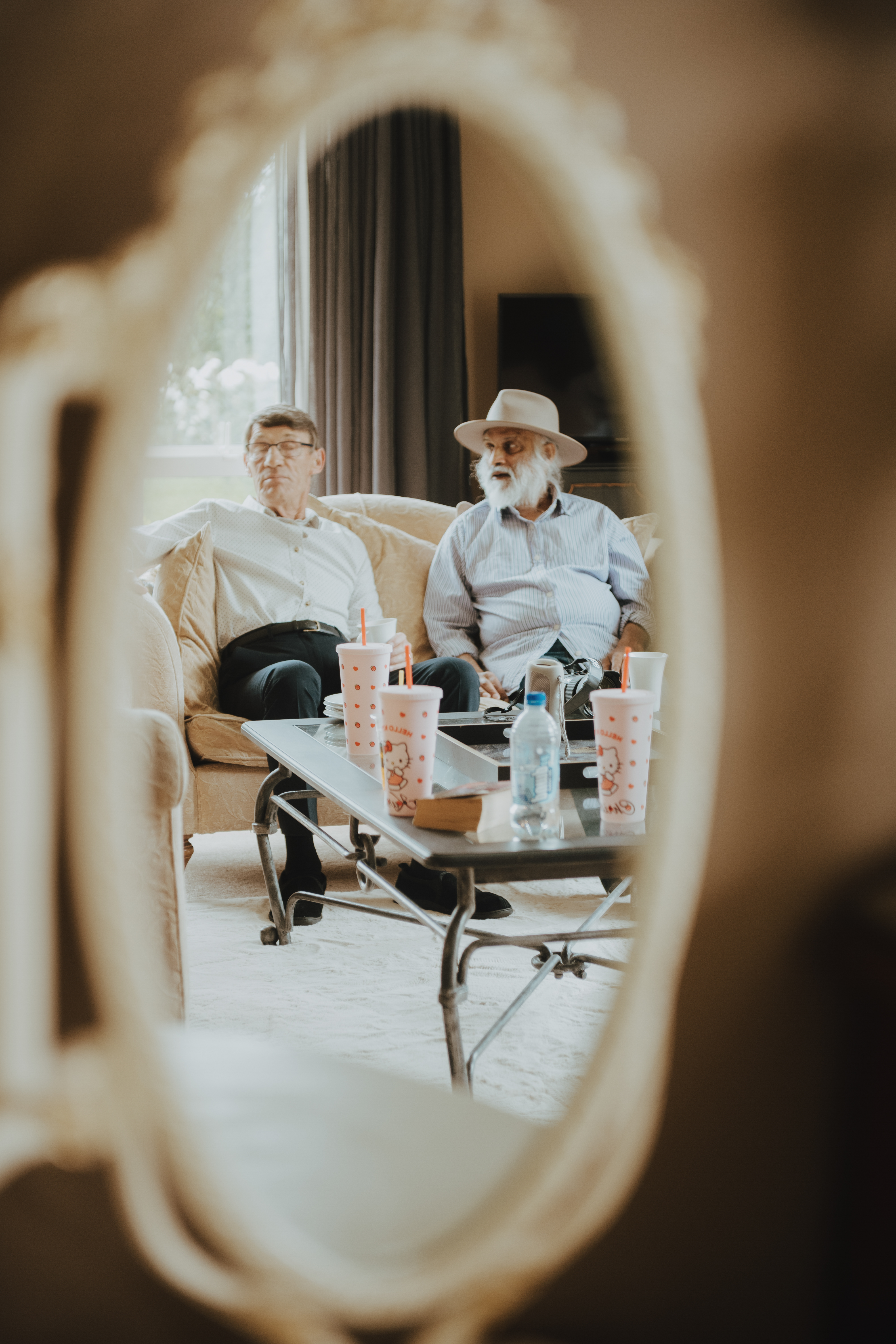 brides father and uncle lounging on the sofa relaxing