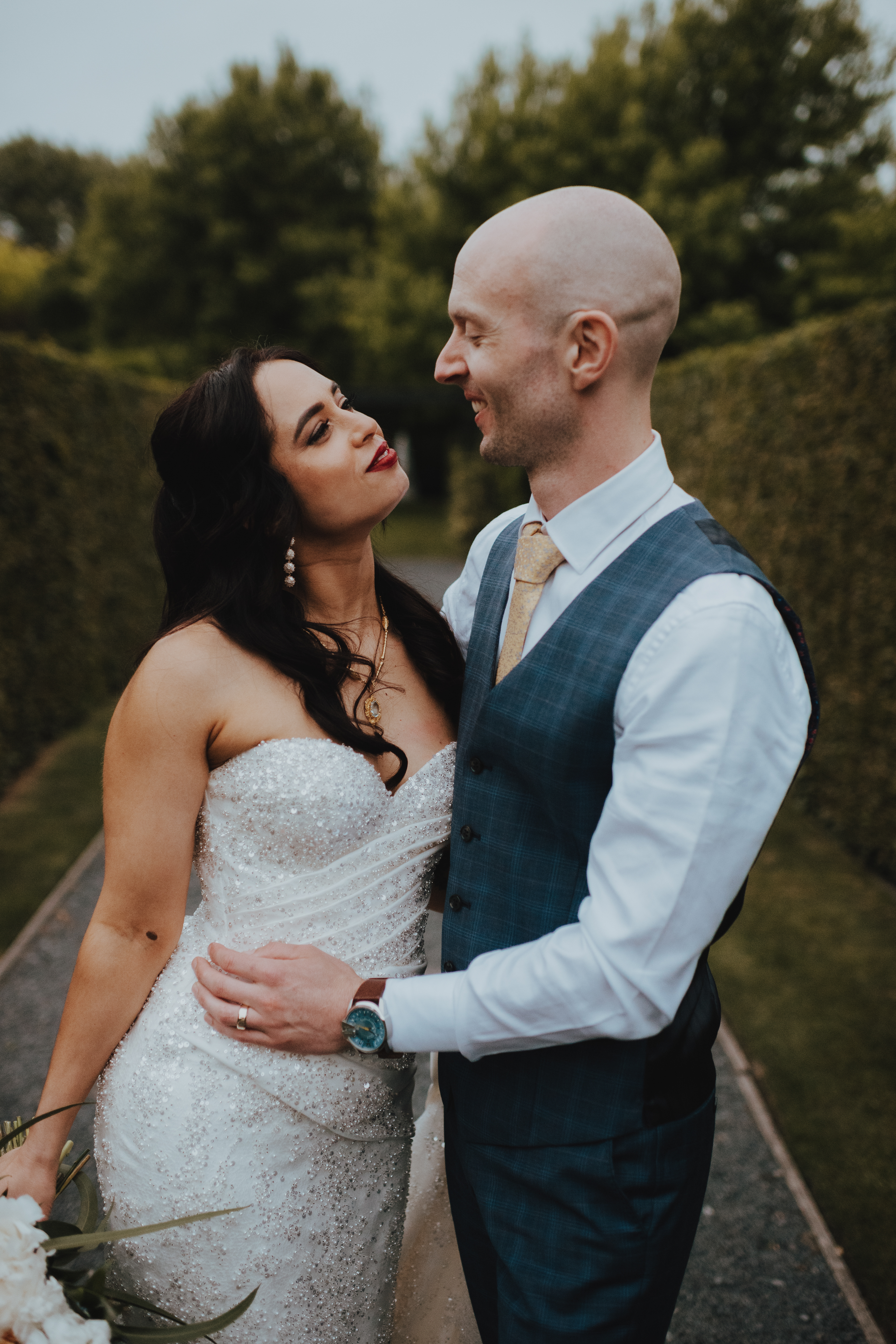 couple smiling at each other during sunset photos