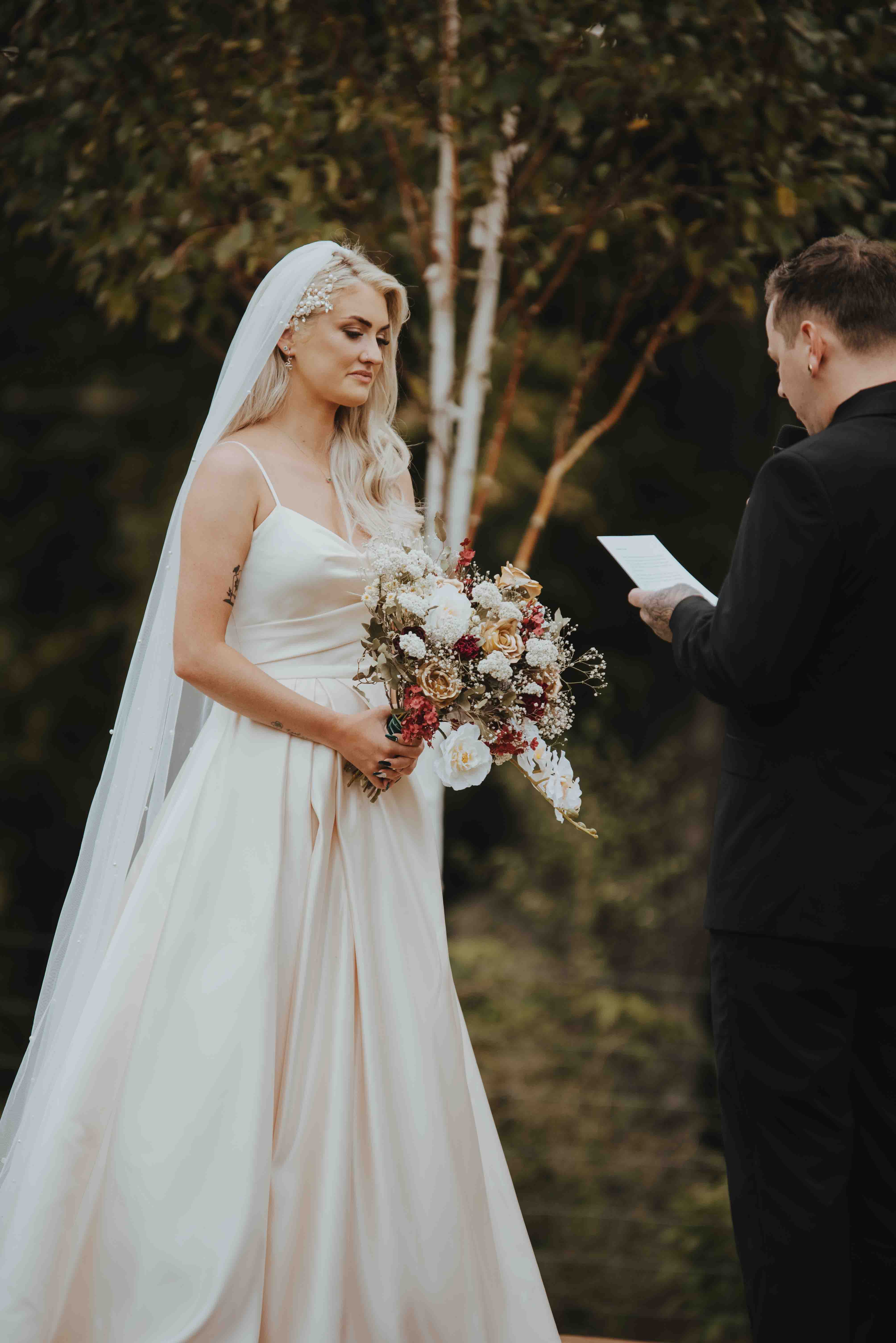 bride watching and listening to vows from groom