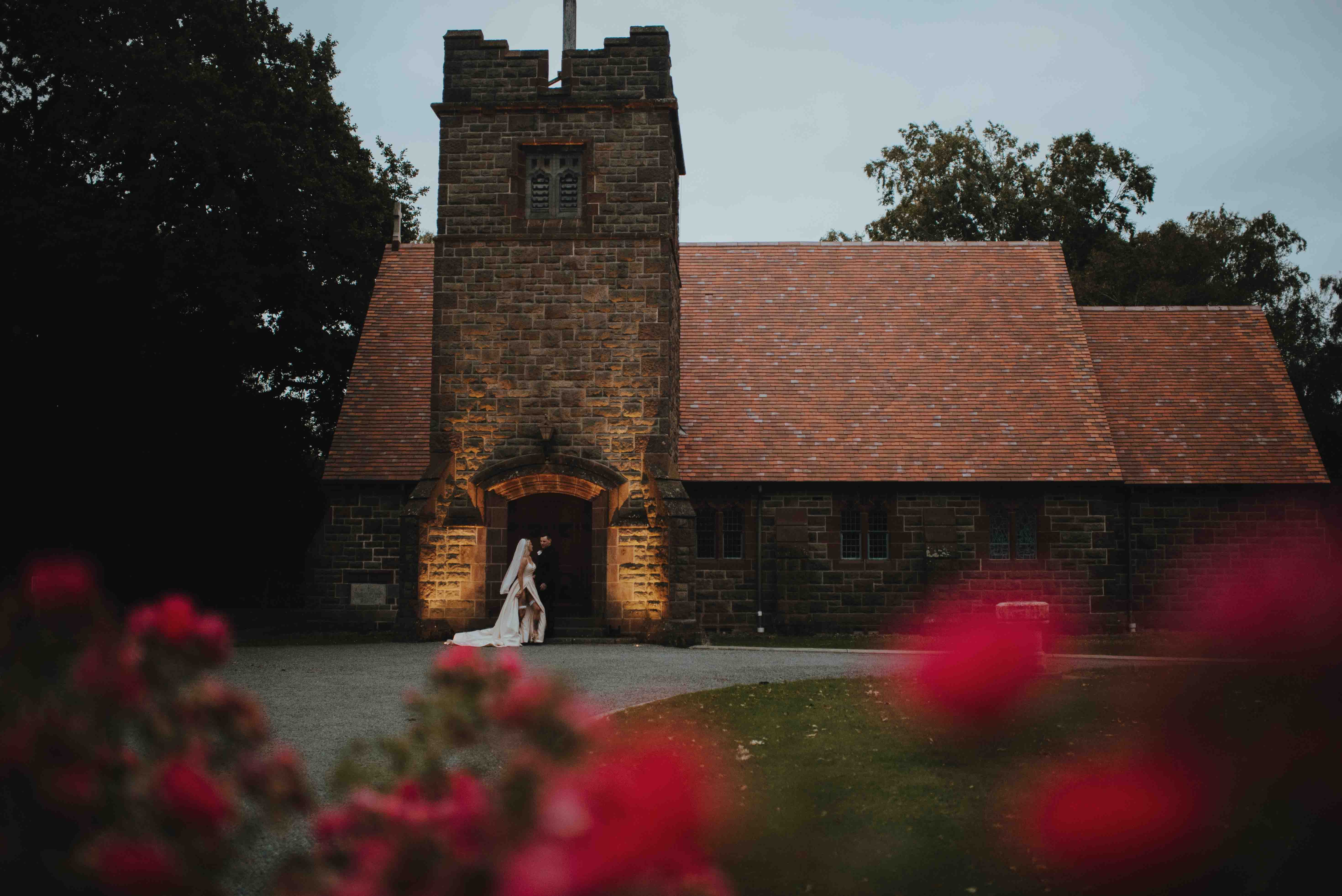 newlyweds in front of tai tapu church at sunset