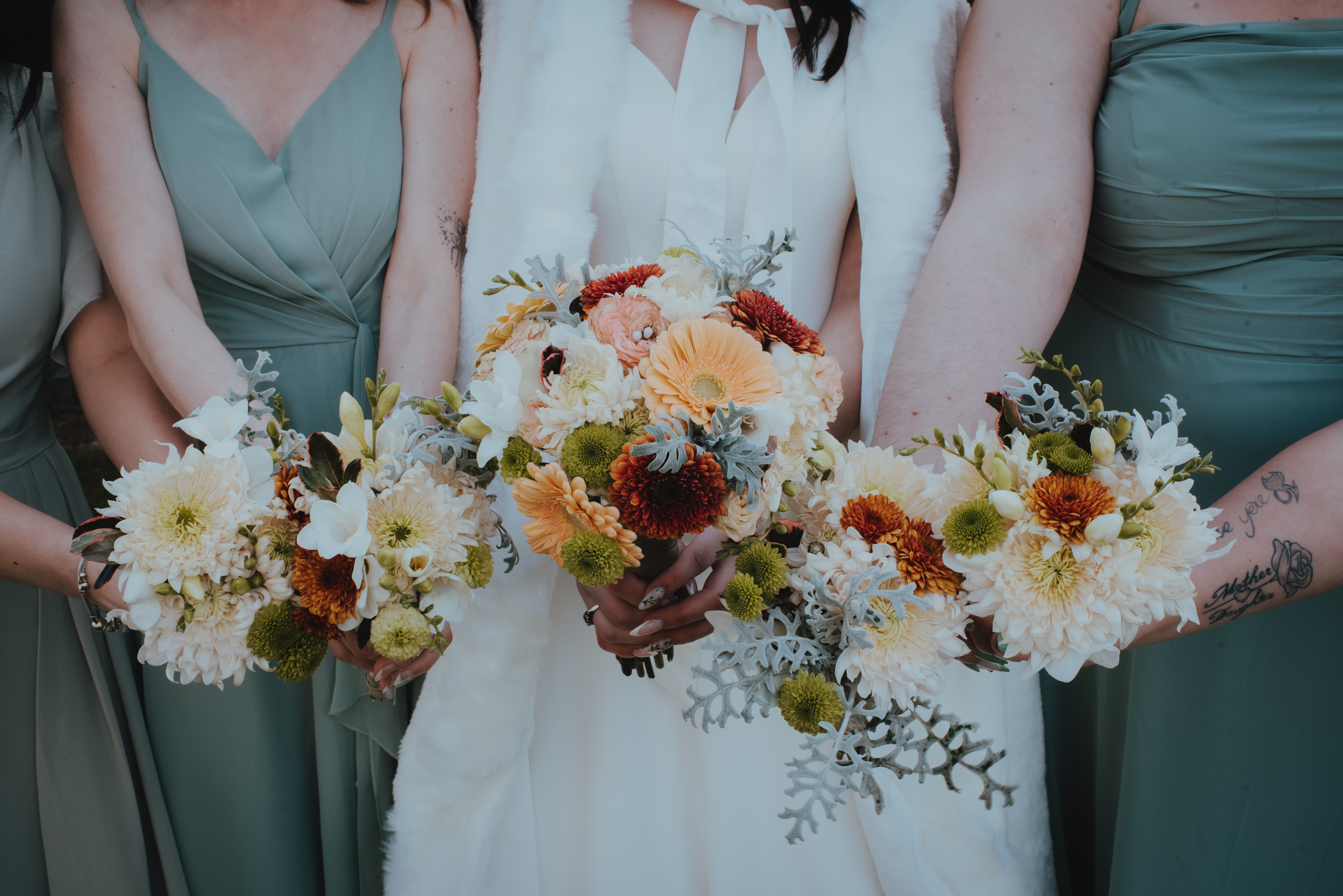 close up of bride and bridesmaids holding bouquets
