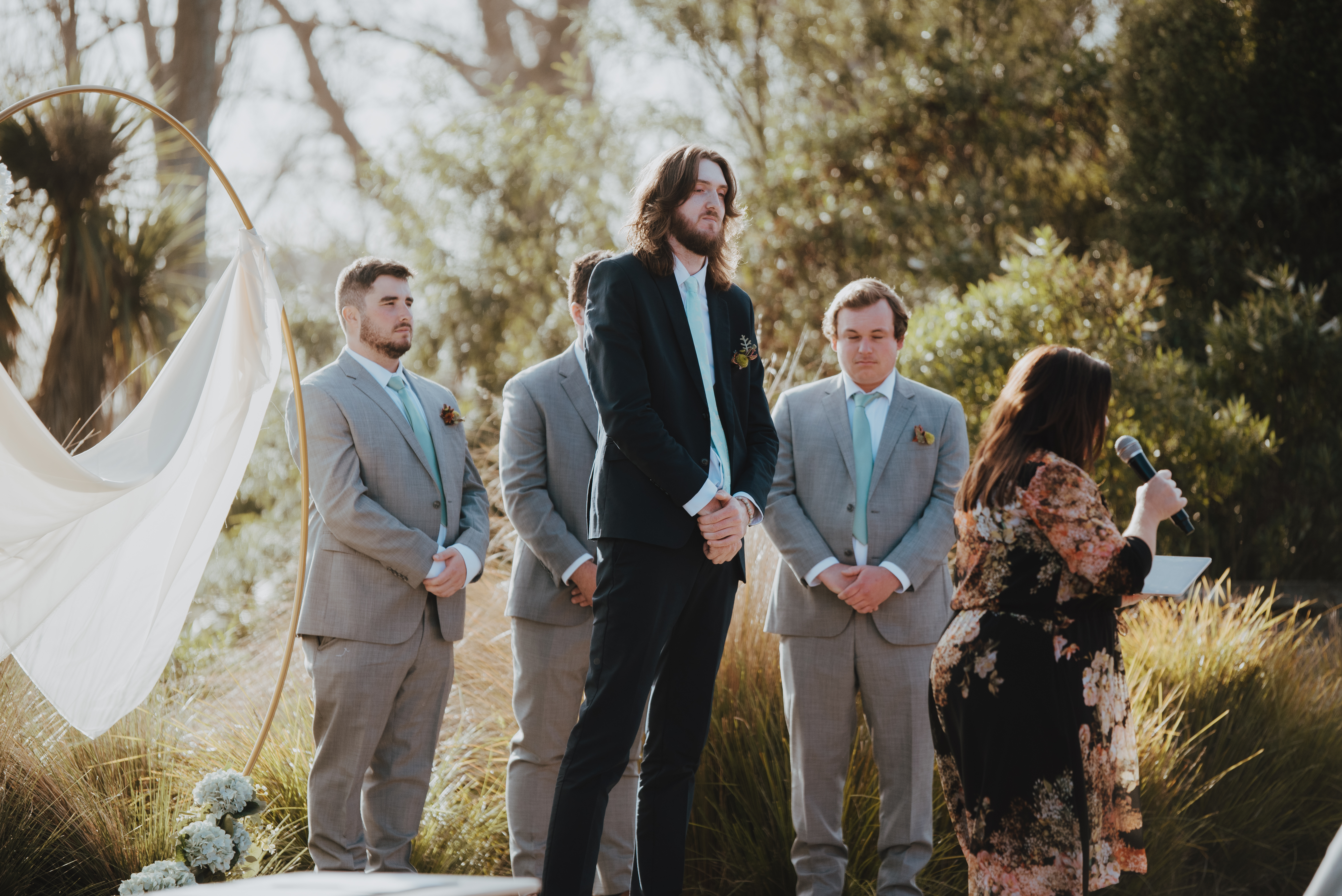 groom waiting patiently at "alter"