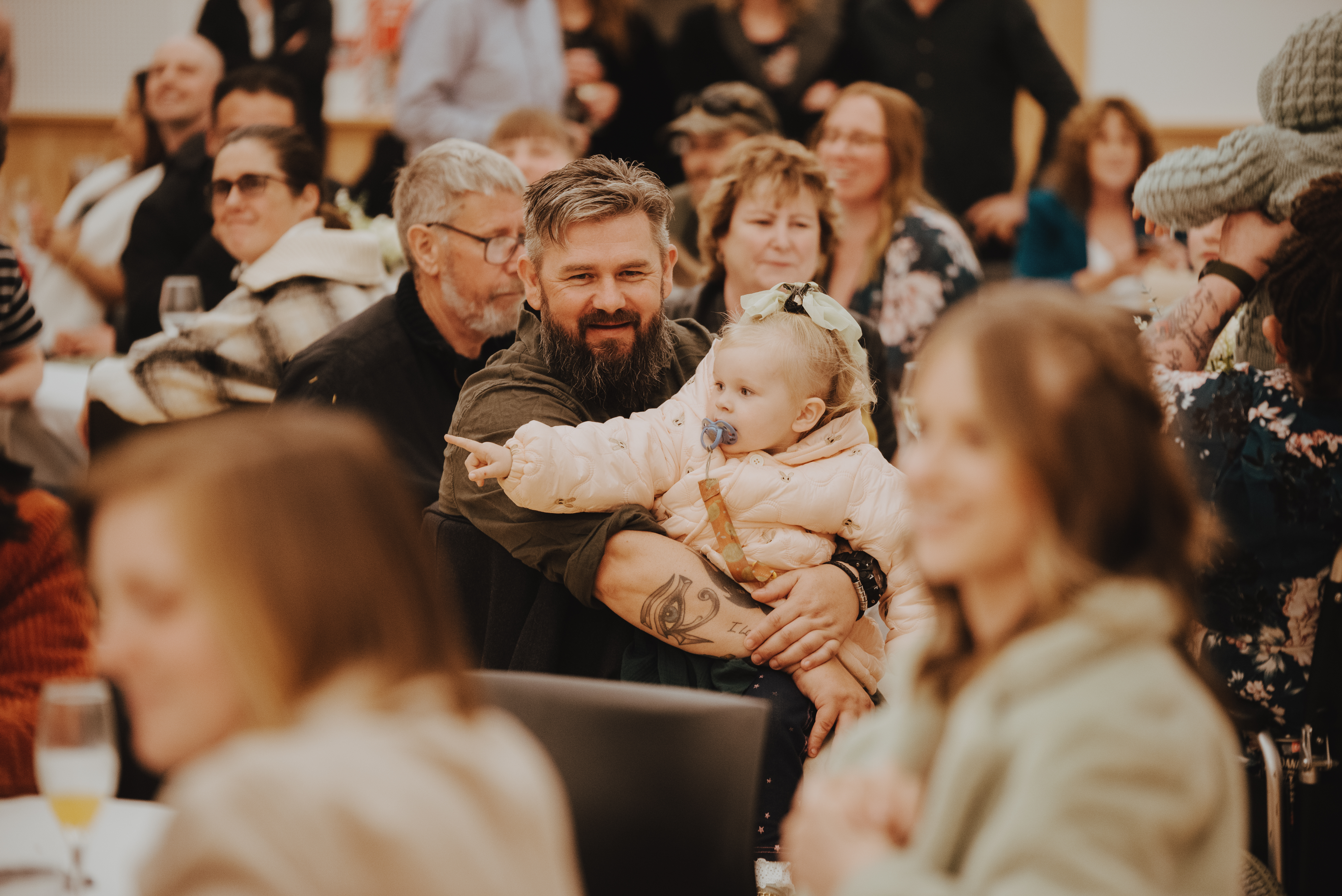 male guest holding his young grand-daughter