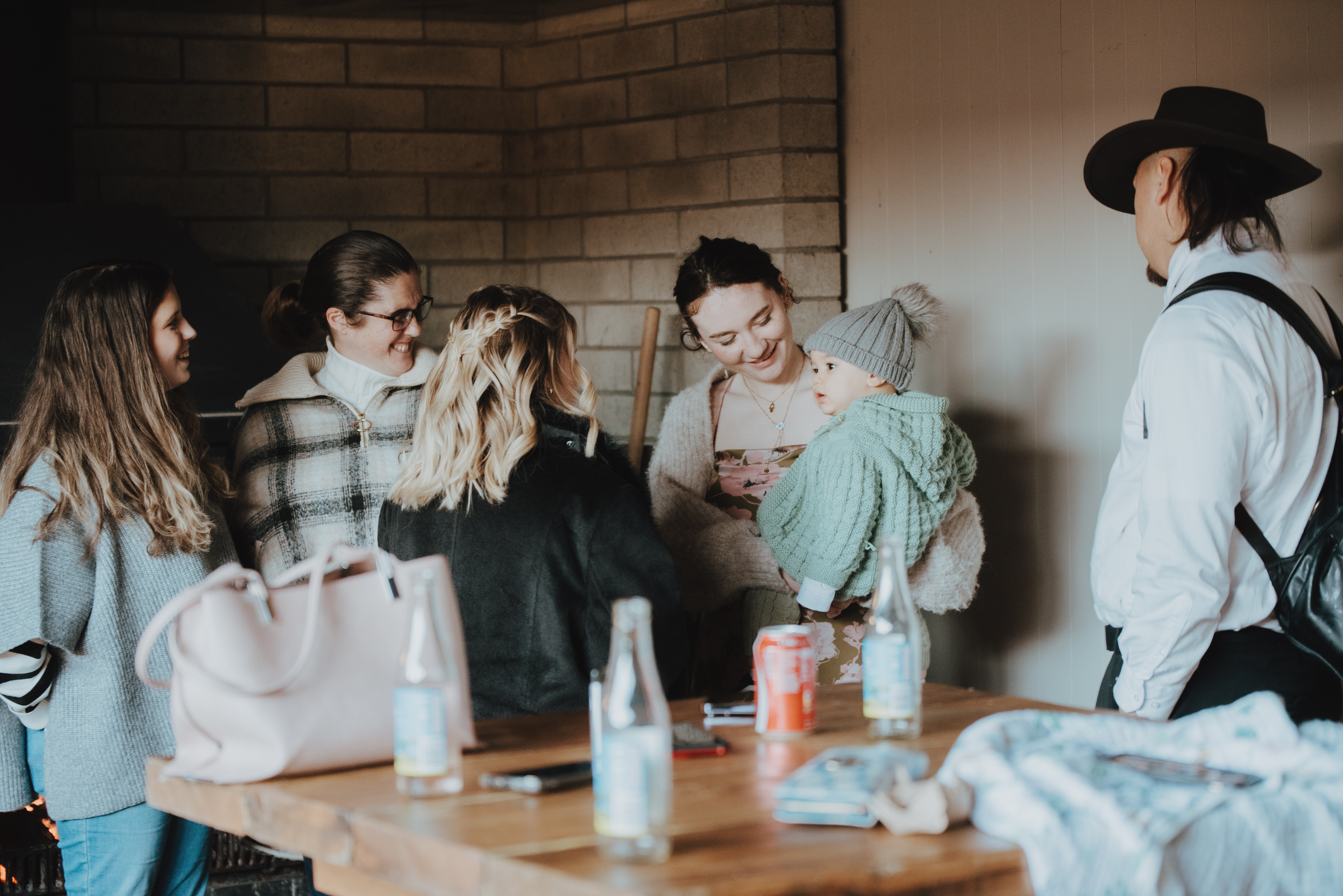 guests mingling and fussing over baby