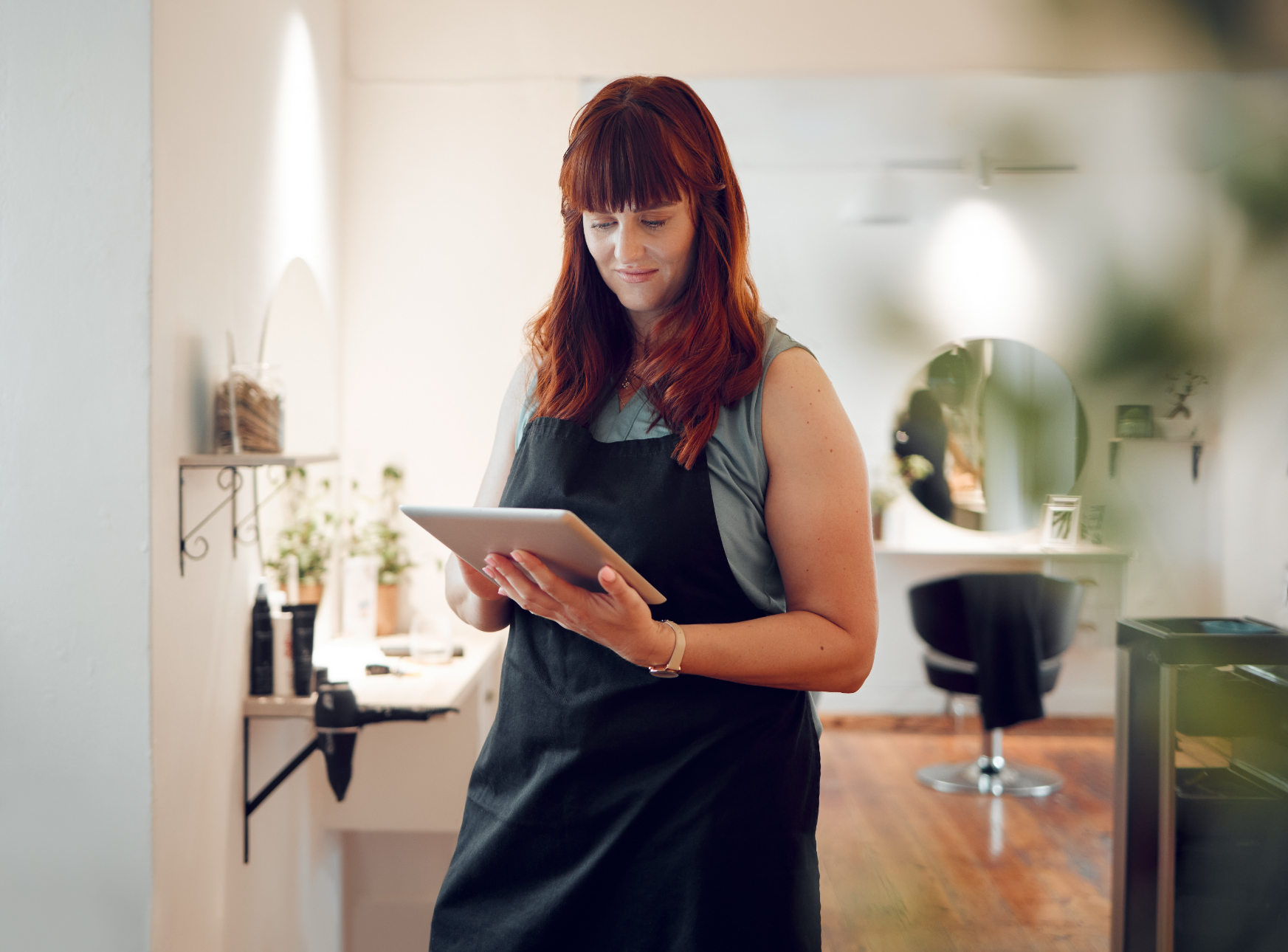 Salon Owner holding a tablet