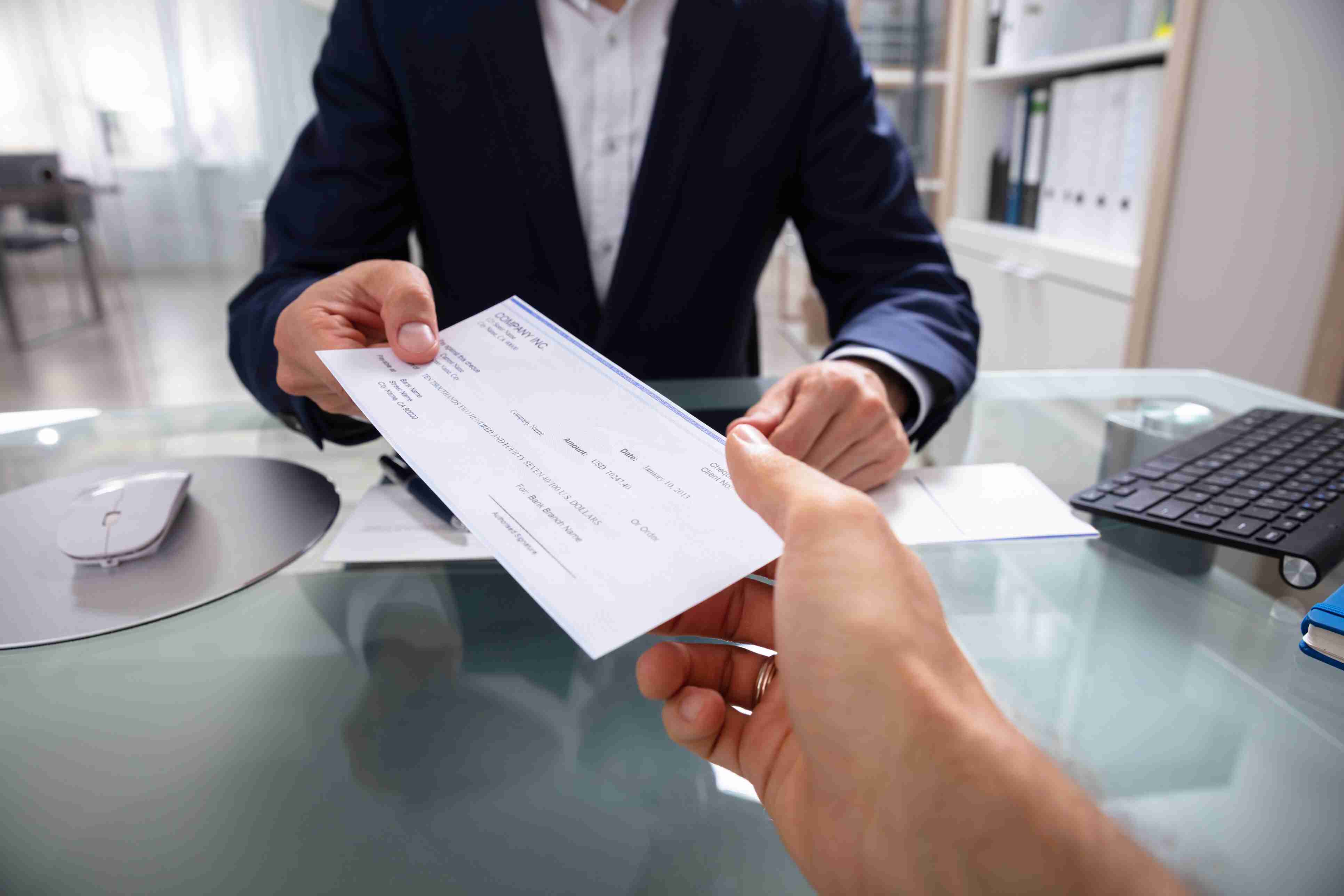 Attorney giving client a check