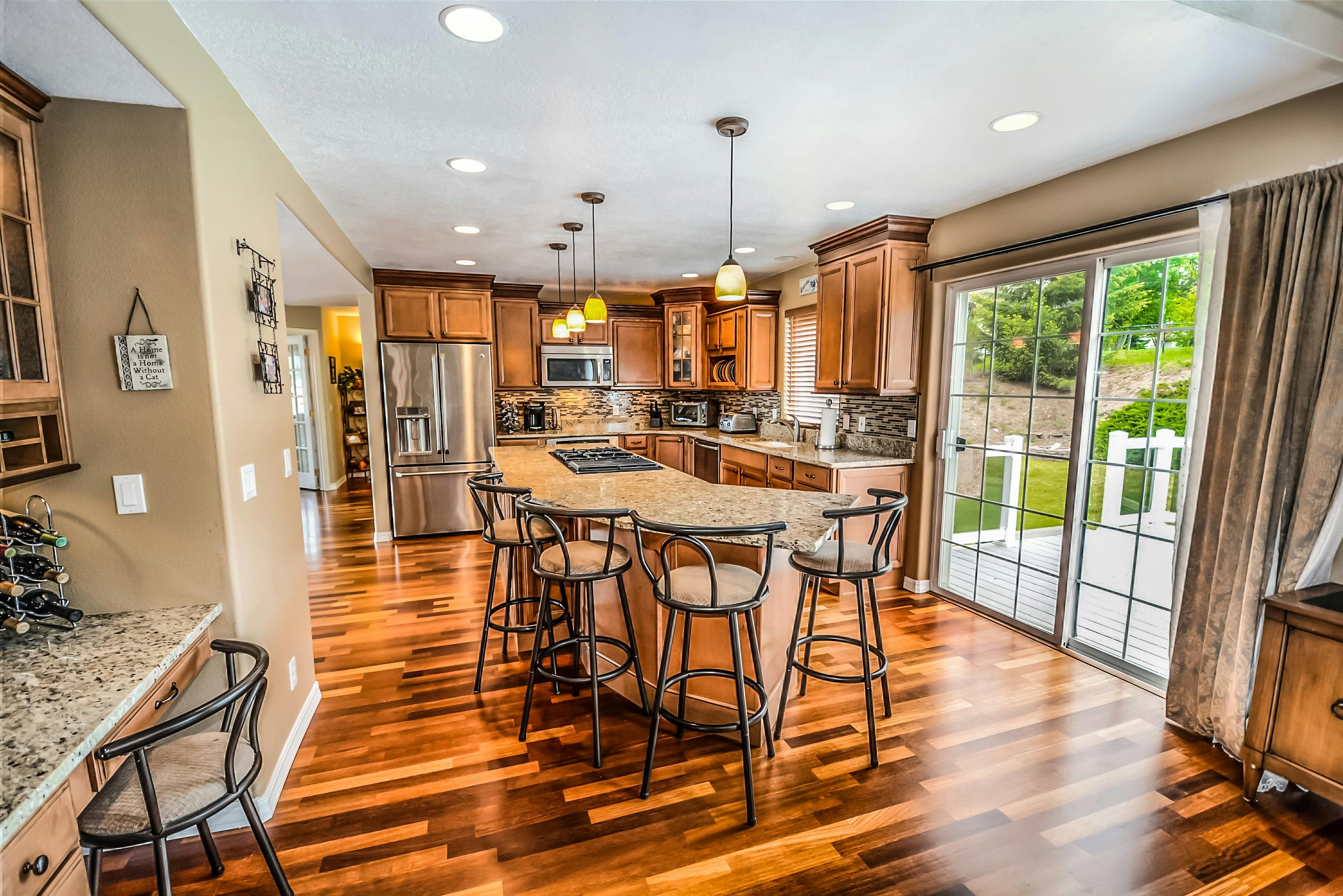 A sleek, modern luxury kitchen with dark cabinets and a marble island.