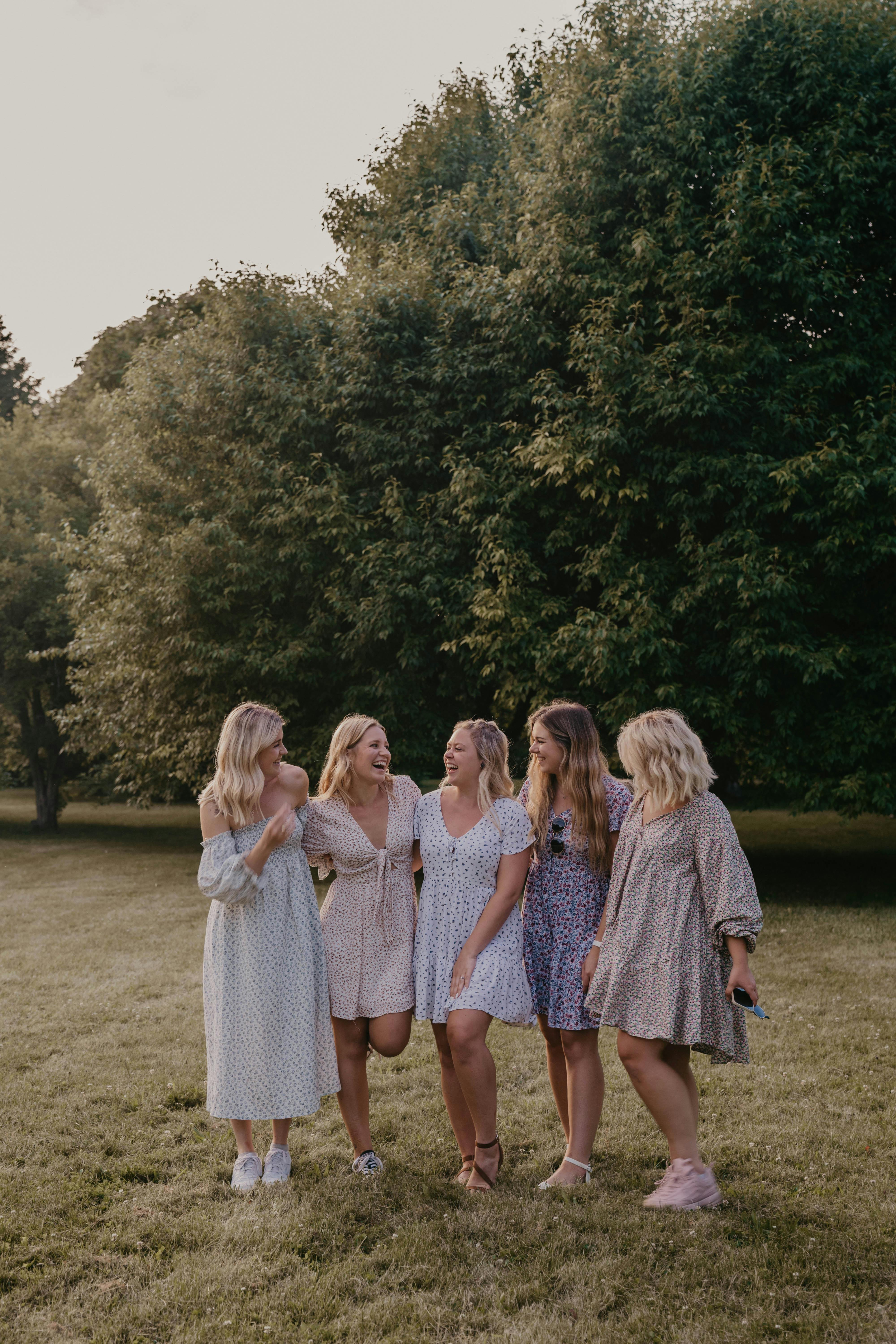 Group of women laughing together outdoors Group of women laughing together outdoors