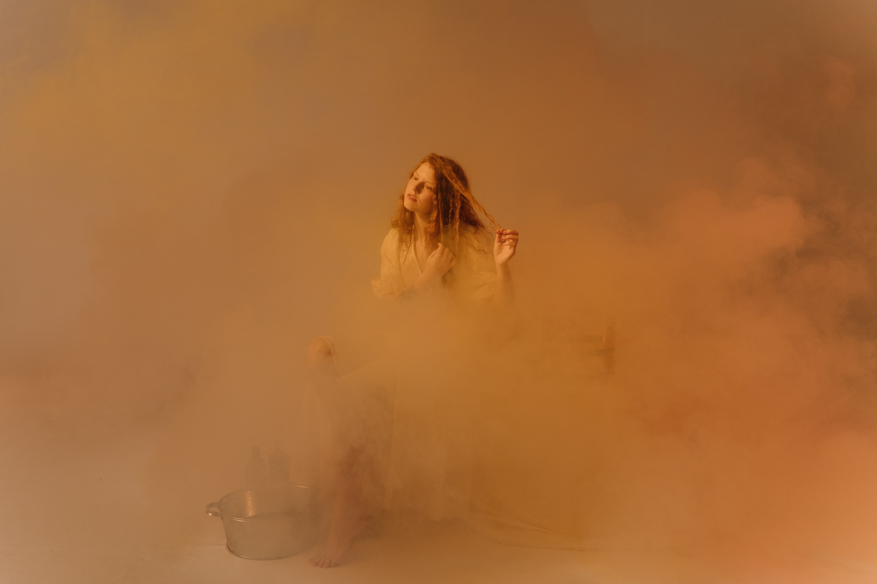 Woman in Dress Sitting While Holding Hair