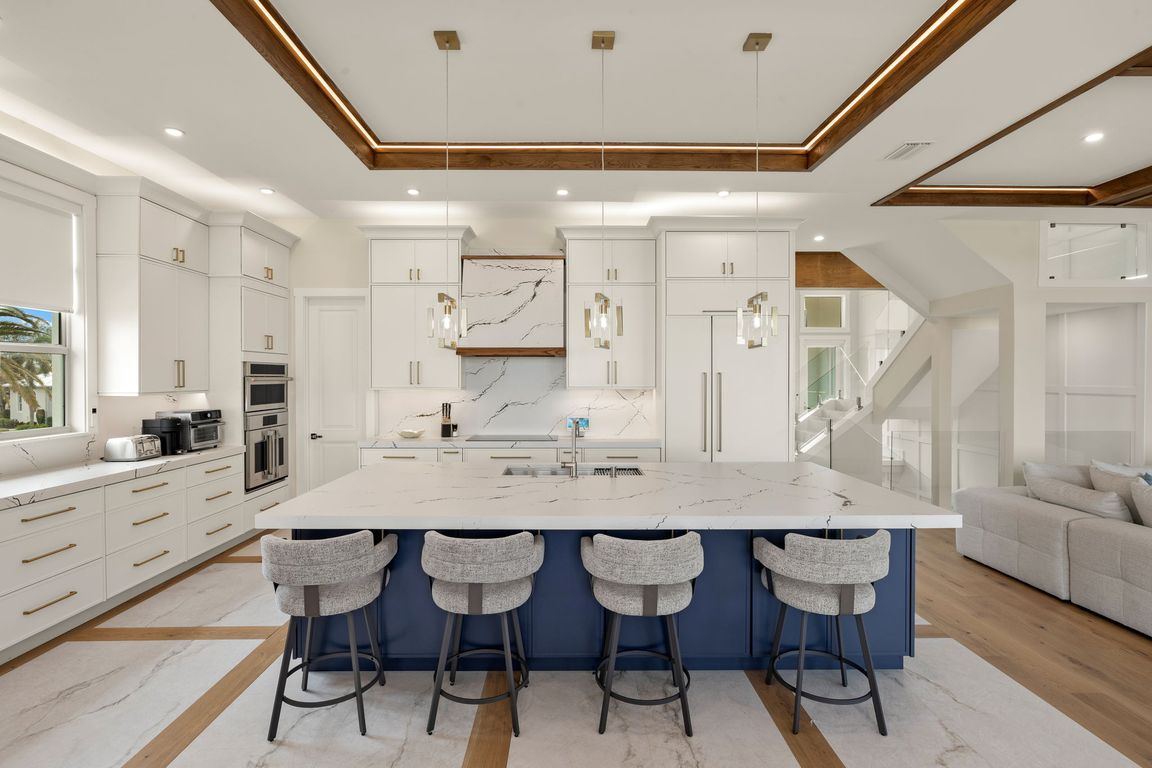 Luxury kitchen remodeling in Bonita Springs with quartz island and pendant lighting