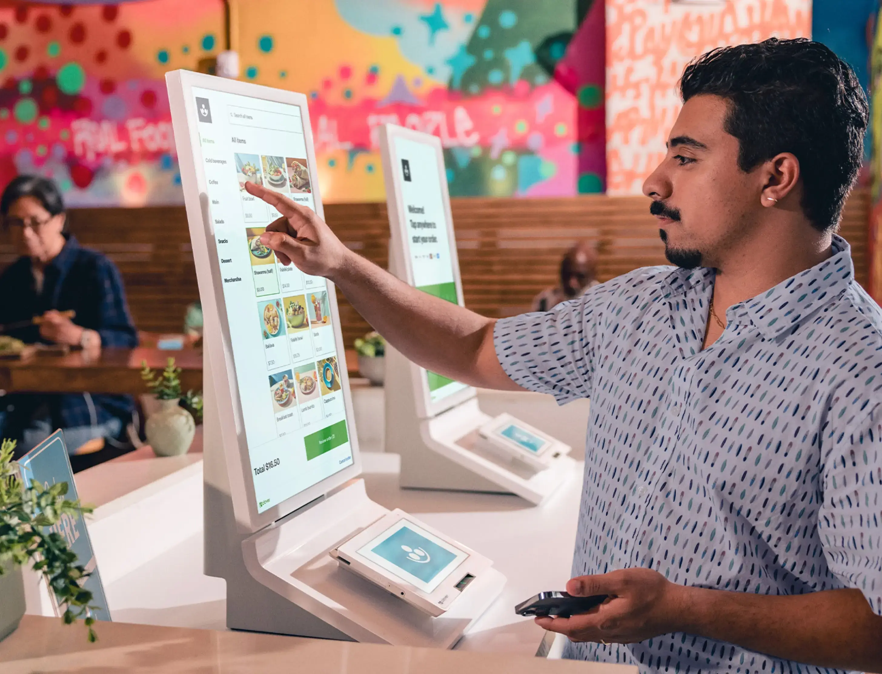 Guests ordering at a fast‑casual kiosk