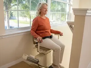 A comfortable stair lift installed on a residential staircase.