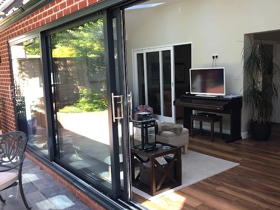 a cozy living space remodeling with large sliding glass doors opening to a patio.