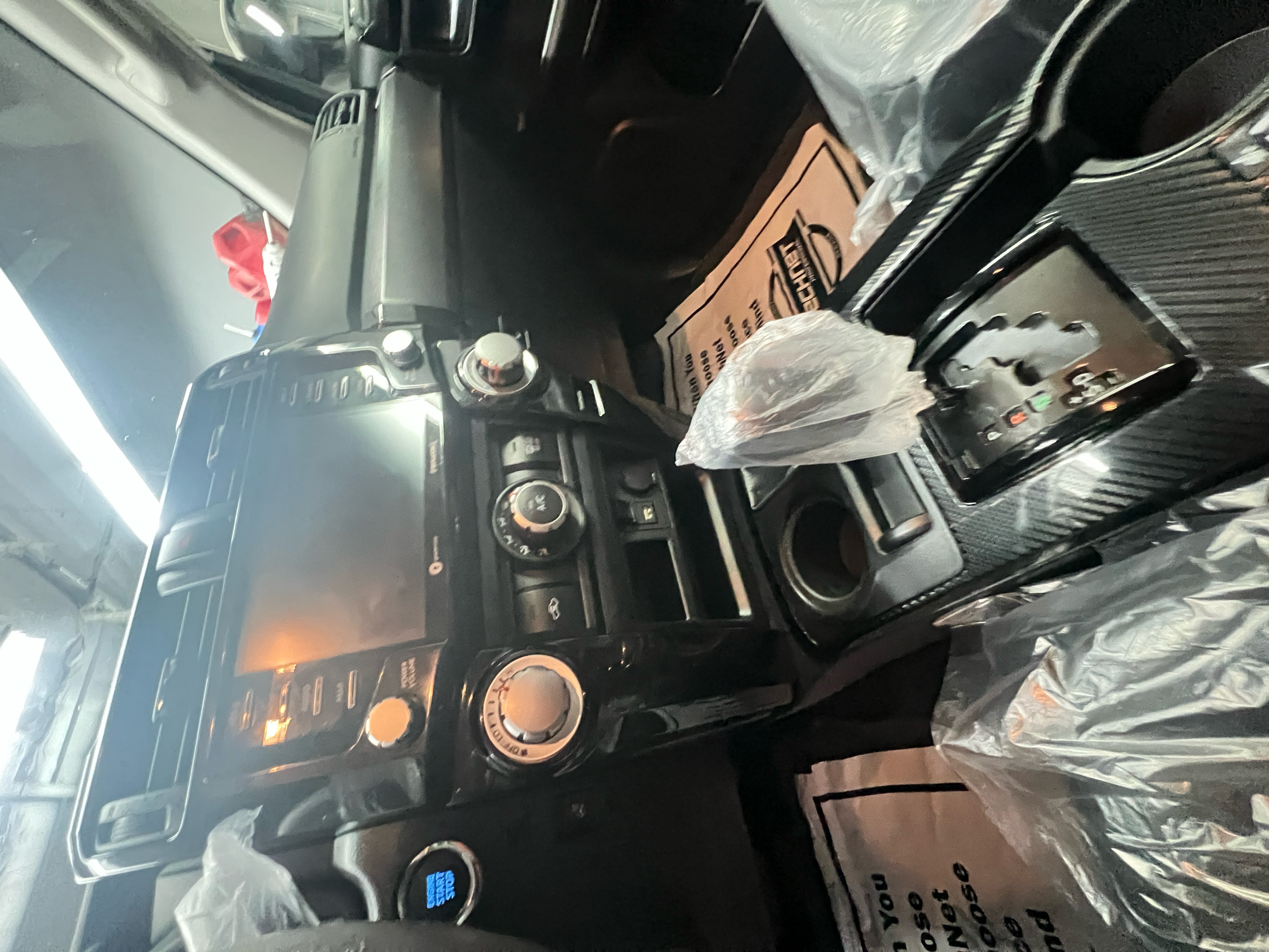 Close-up of freshly cleaned air vents, cup holders, and center console in a vehicle, emphasizing thoroughness in hard-to-reach areas.