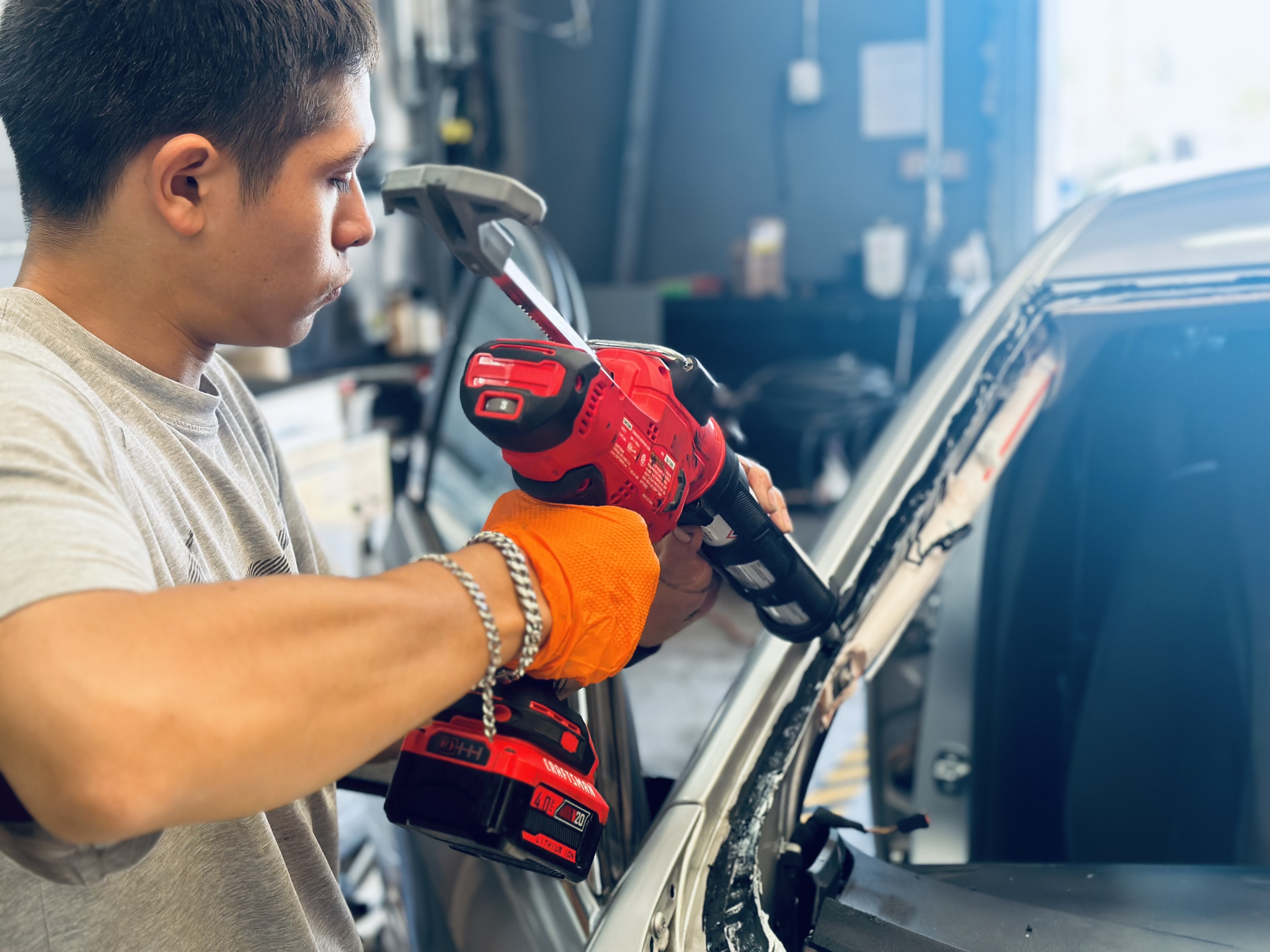 ALT text: “Certified technician from RND Auto Detailing repairing a vehicle windshield, showcasing expertise in glass repair services.” ALT text: “Certified technician from RND Auto Detailing repairing a vehicle windshield, showcasing expertise in glass repair services.”