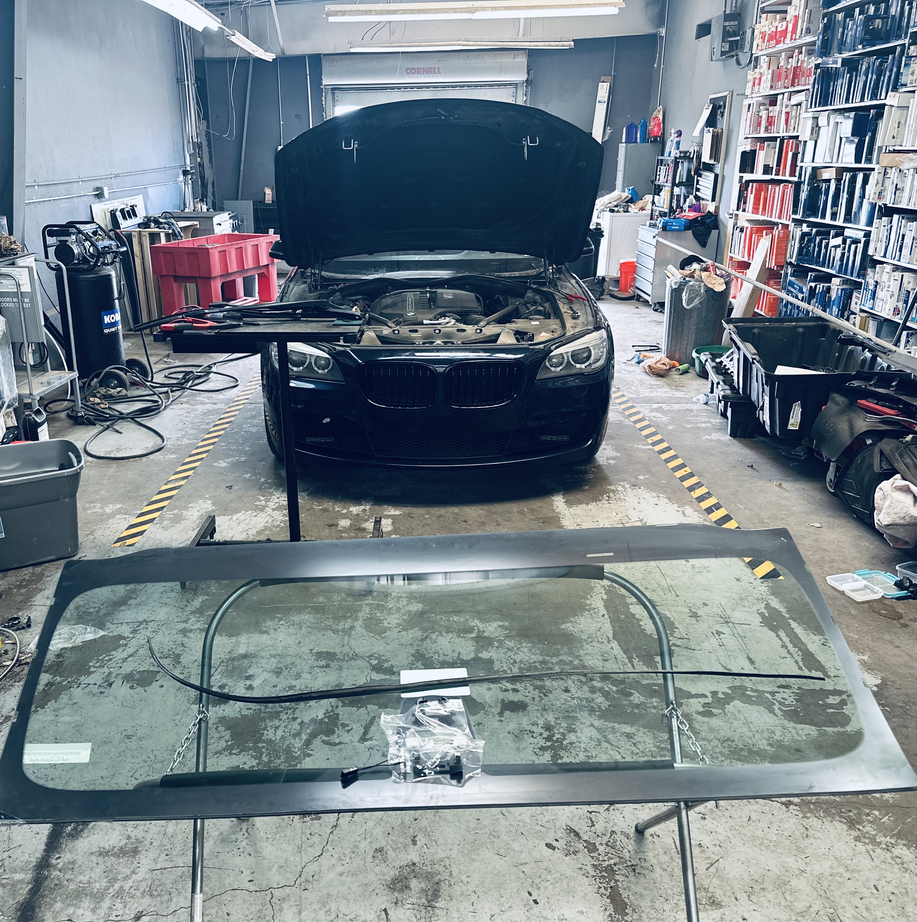 Technicians at RND Auto Detailing carefully remove a damaged windshield from a car, preparing to install new OEM-quality glass. Technicians at RND Auto Detailing carefully remove a damaged windshield from a car, preparing to install new OEM-quality glass.