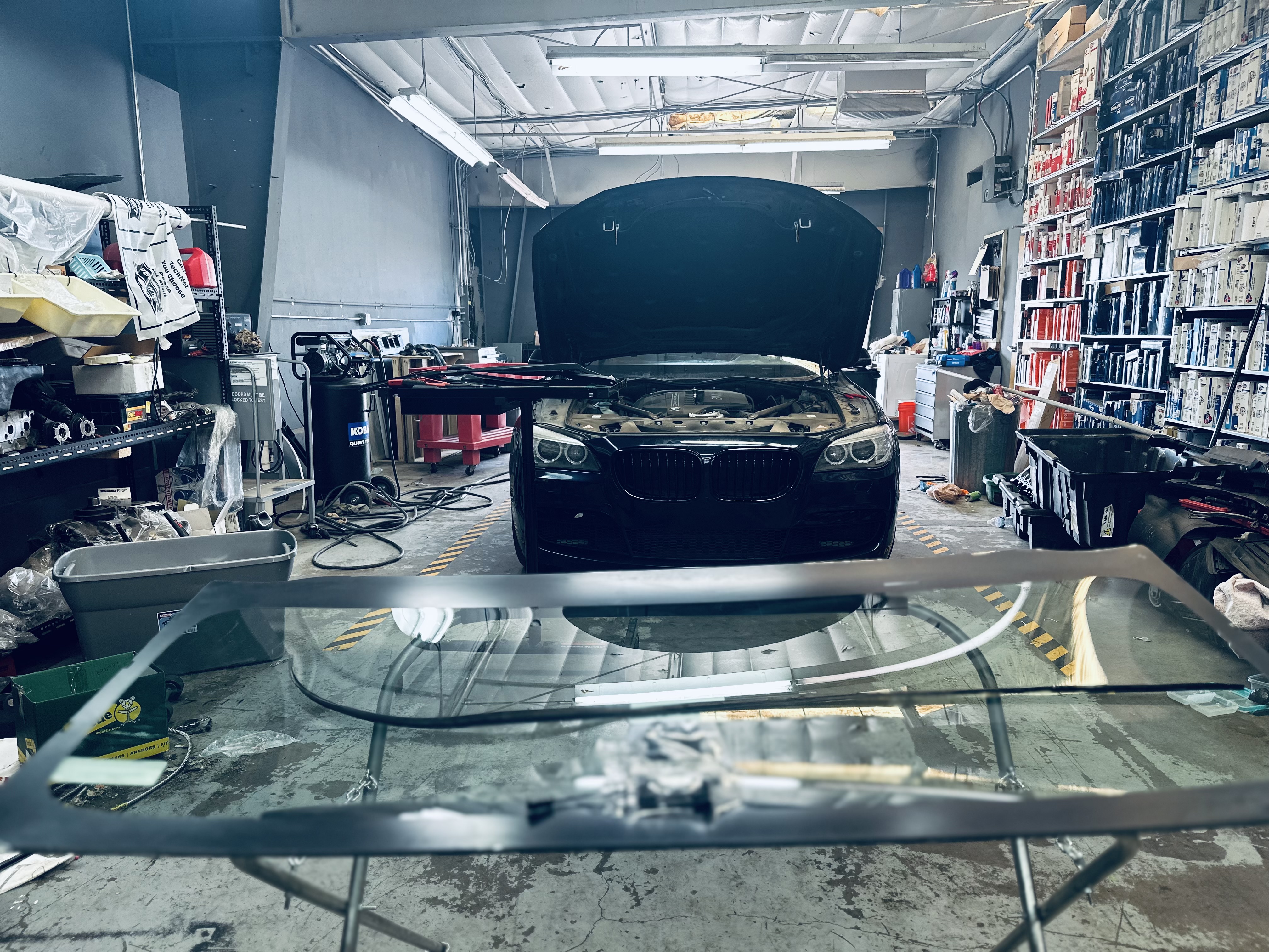 “RND Auto technician carefully replacing the cracked windshield on a 2018 BMW 3 Series in the repair bay.” “RND Auto technician carefully replacing the cracked windshield on a 2018 BMW 3 Series in the repair bay.”