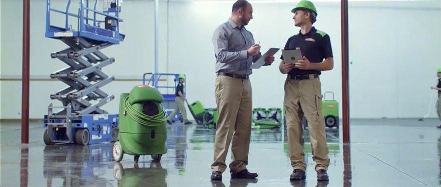 water damage restoration experts discussing insurance claim