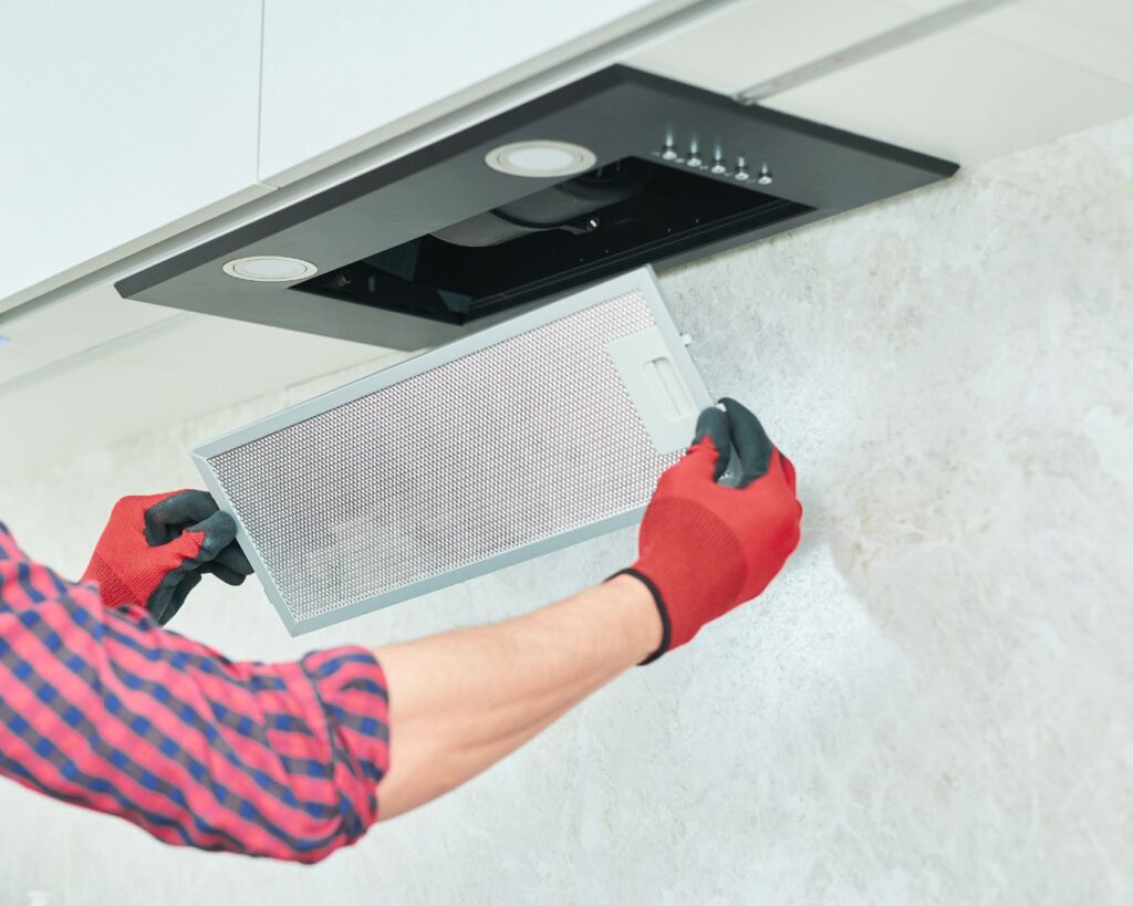 A3D Services cleaner cleaning oven vent in breakroom to prevent costly tenant complaints in Scottsdale.
