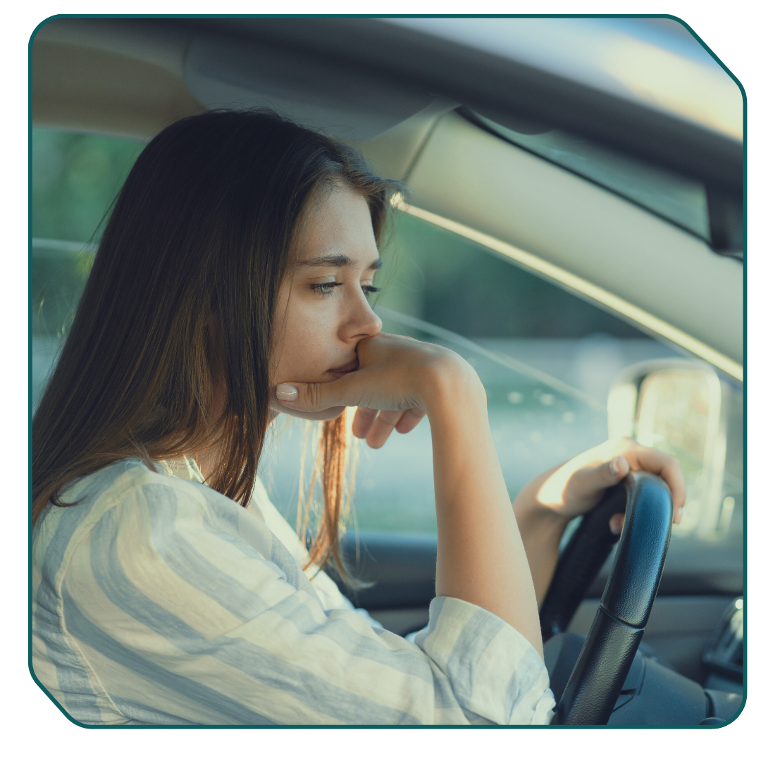Woman looking detached, sad, sitting in a car Woman looking detached, sad, sitting in a car