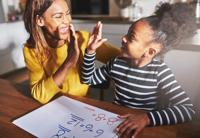 Parent and child celebrating a small math victory