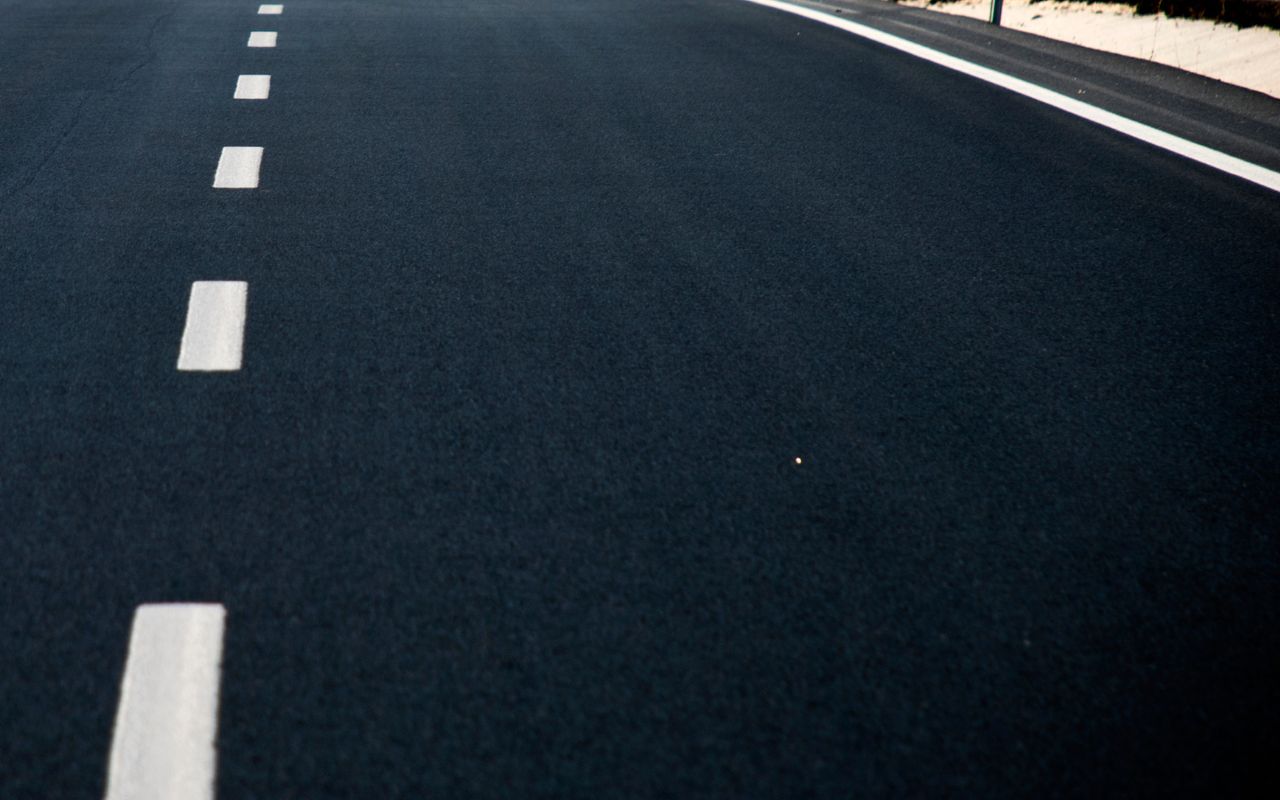Applying sealcoat on commercial asphalt for protection Applying sealcoat on commercial asphalt for protection