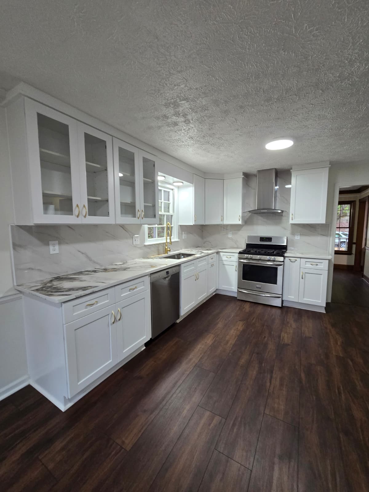 After kitchen remodel – bright modern white kitchen with island and pendant lights