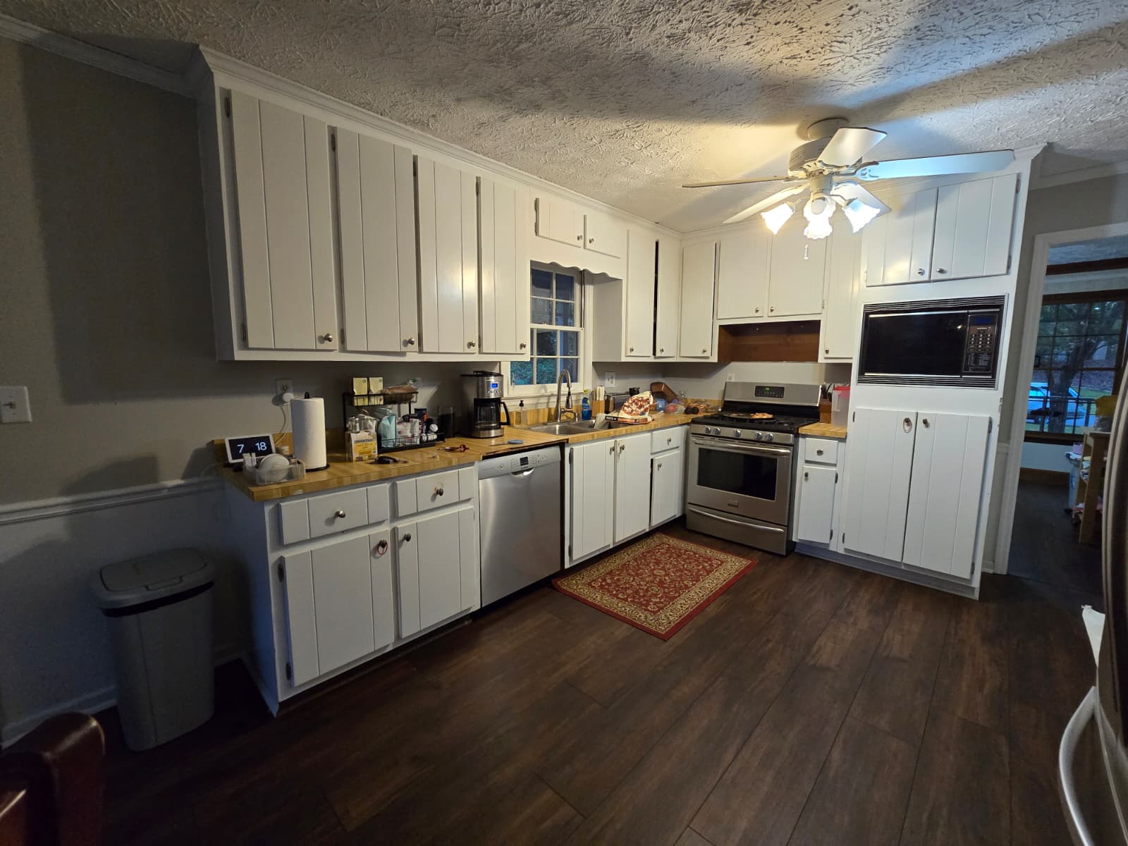 Before kitchen remodel – dark cabinetry and dated lighting