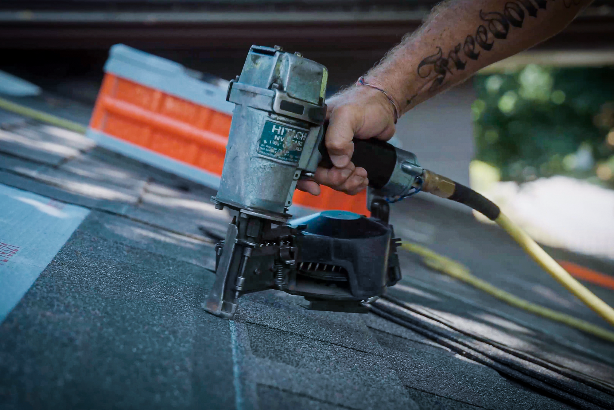 nail gun in use - bmf roofing solutions