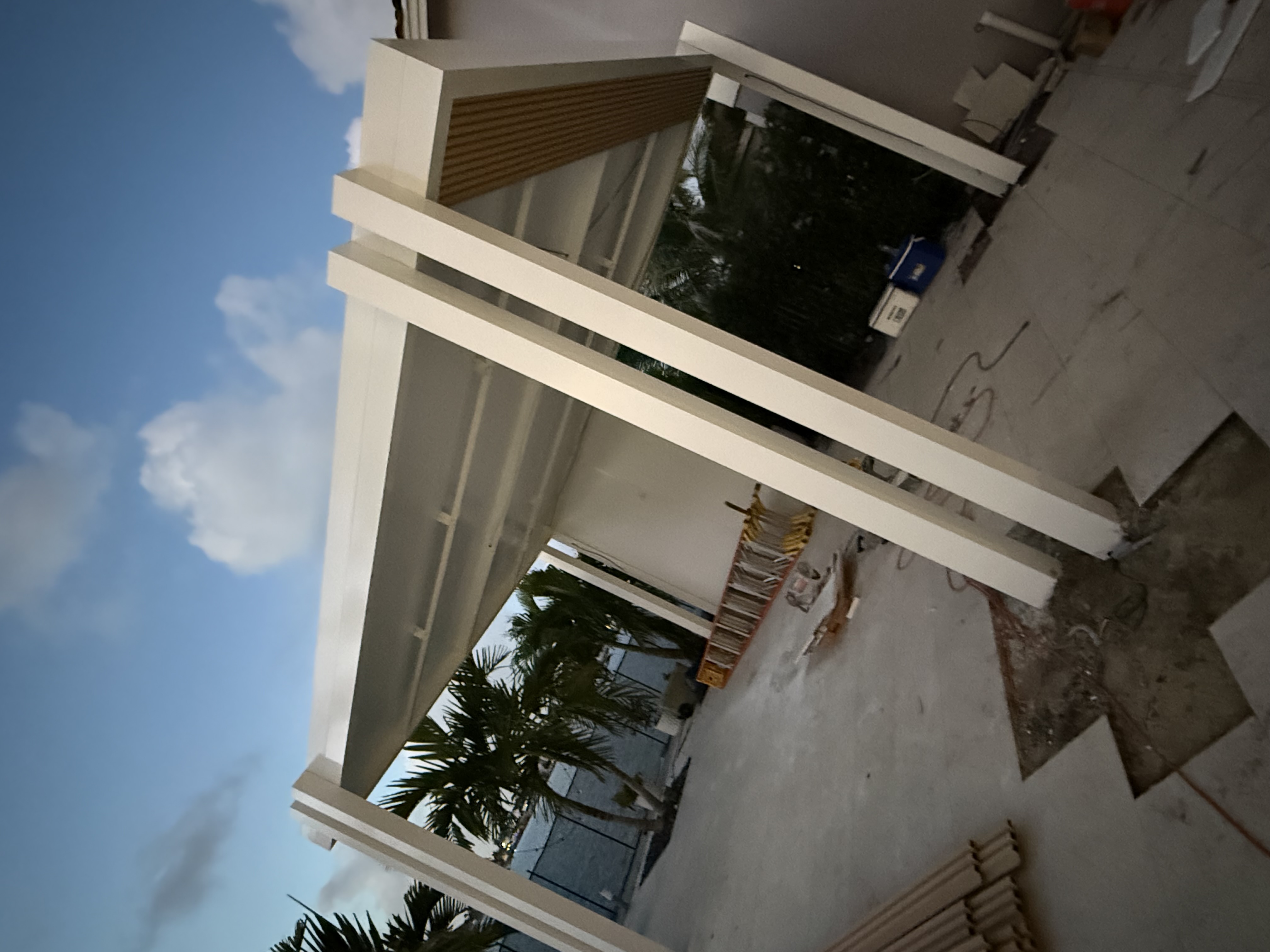 Aluminum outdoor living structure with poolside setting and shade system