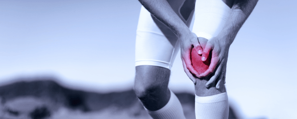 Athlete clutching their knee in pain, with the knee highlighted in red to indicate inflammation or injury. Represents joint pain from inflammation, Athlete clutching their knee in pain, with the knee highlighted in red to indicate inflammation or injury. Represents joint pain from inflammation,