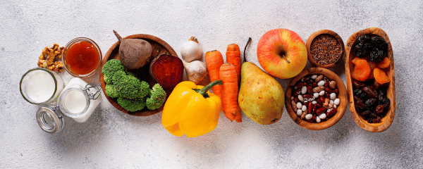 A colorful assortment of whole foods including fruits, vegetables, dairy, legumes, nuts, and seeds—common culprits of food sensitivities despite being nutrient-dense and healthy for many. A colorful assortment of whole foods including fruits, vegetables, dairy, legumes, nuts, and seeds—common culprits of food sensitivities despite being nutrient-dense and healthy for many.