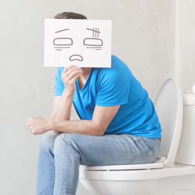 sitting on a toilet holding a cartoon face showing discomfort, humorously illustrating digestive distress—a common symptom of celiac disease. sitting on a toilet holding a cartoon face showing discomfort, humorously illustrating digestive distress—a common symptom of celiac disease.