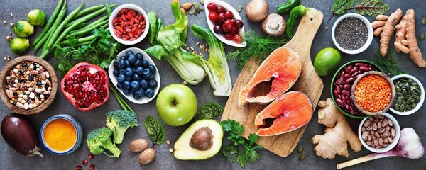 Colorful spread of whole, nutrient-dense foods including fruits, vegetables, fish, seeds, and herbs—representing the potential for healing and balance through personalized nutrition and mindful eating. Colorful spread of whole, nutrient-dense foods including fruits, vegetables, fish, seeds, and herbs—representing the potential for healing and balance through personalized nutrition and mindful eating.