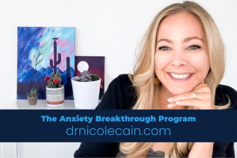 Professional photo of a smiling blonde woman, Dr. Nicole Cain, resting her chin on her hand. In the background are potted succulents and a desert-themed painting. A blue banner at the bottom reads: "The Anxiety Breakthrough Program, drnicolecain.com" Professional photo of a smiling blonde woman, Dr. Nicole Cain, resting her chin on her hand. In the background are potted succulents and a desert-themed painting. A blue banner at the bottom reads: "The Anxiety Breakthrough Program, drnicolecain.com"