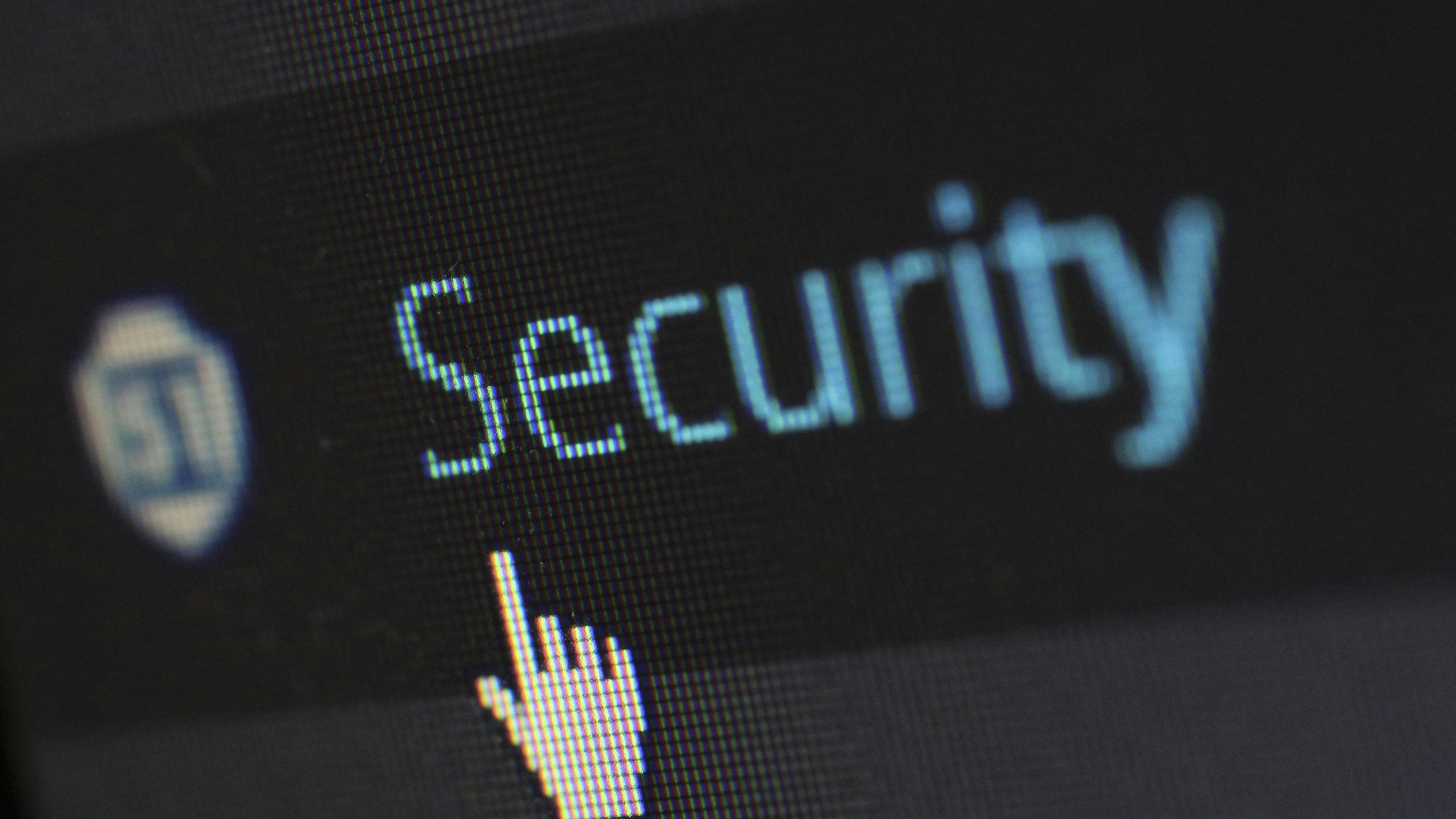 A mouse cursor points toward the word "Security" on a computer screen.