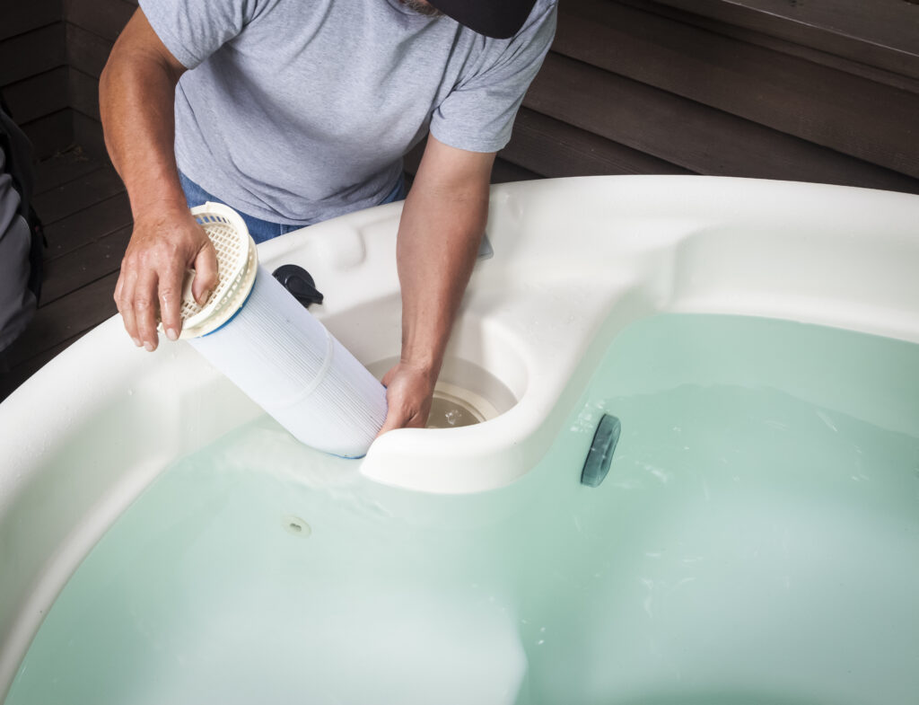 Professional hot tub technician servicing a spa in Park City