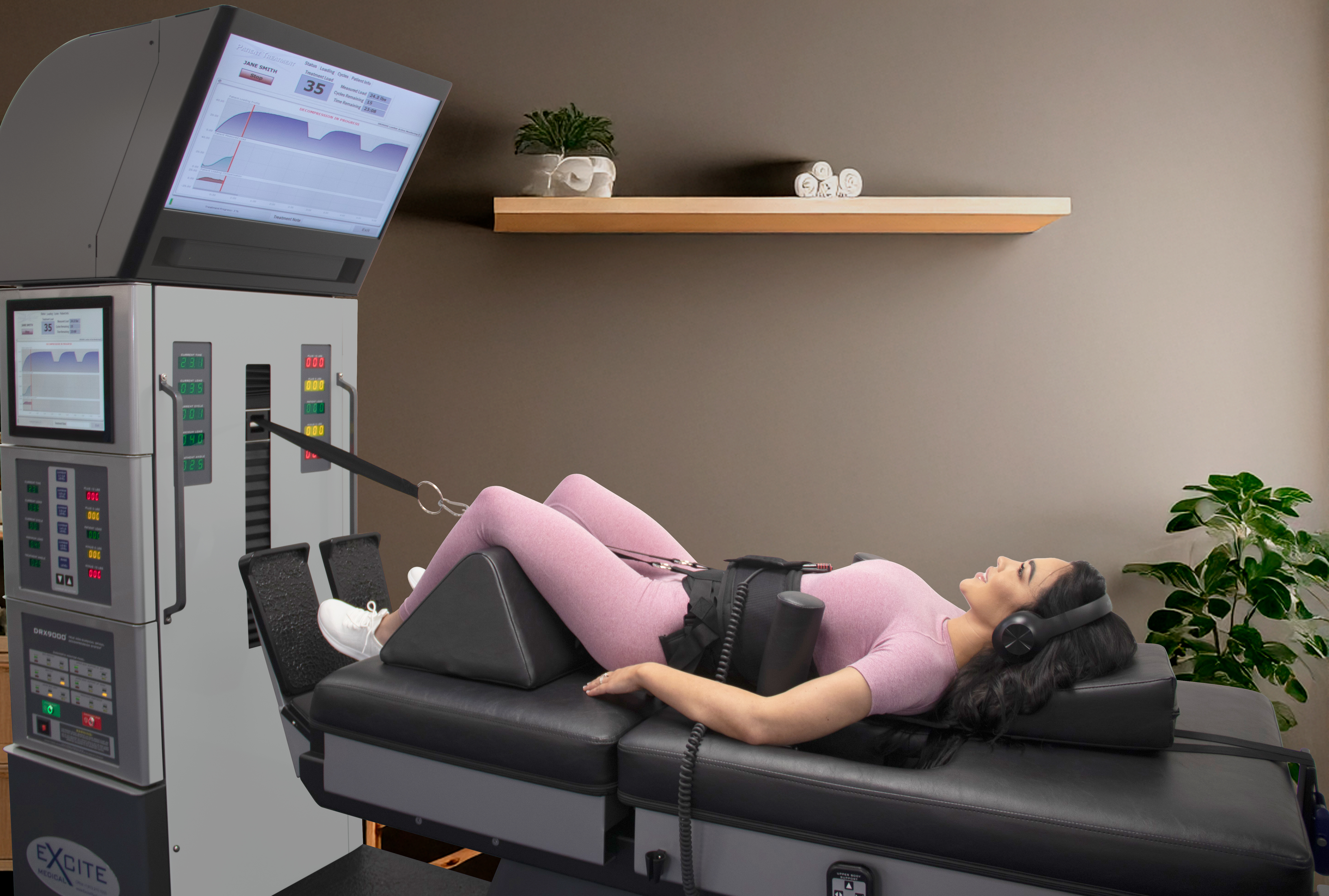 A photo of a practitioner at a control panel of the DRX 9000, explaining the settings and treatment plan to a patient, emphasizing the personalized aspect of the care.