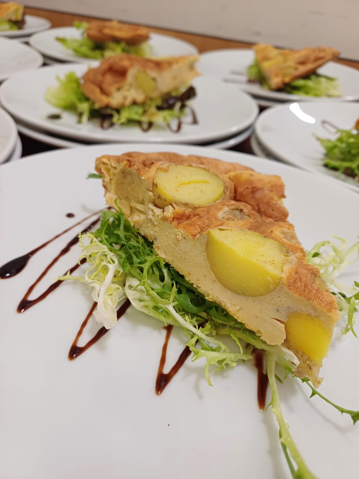 a slice of fritatta and lettuce leaves a slice of fritatta and lettuce leaves