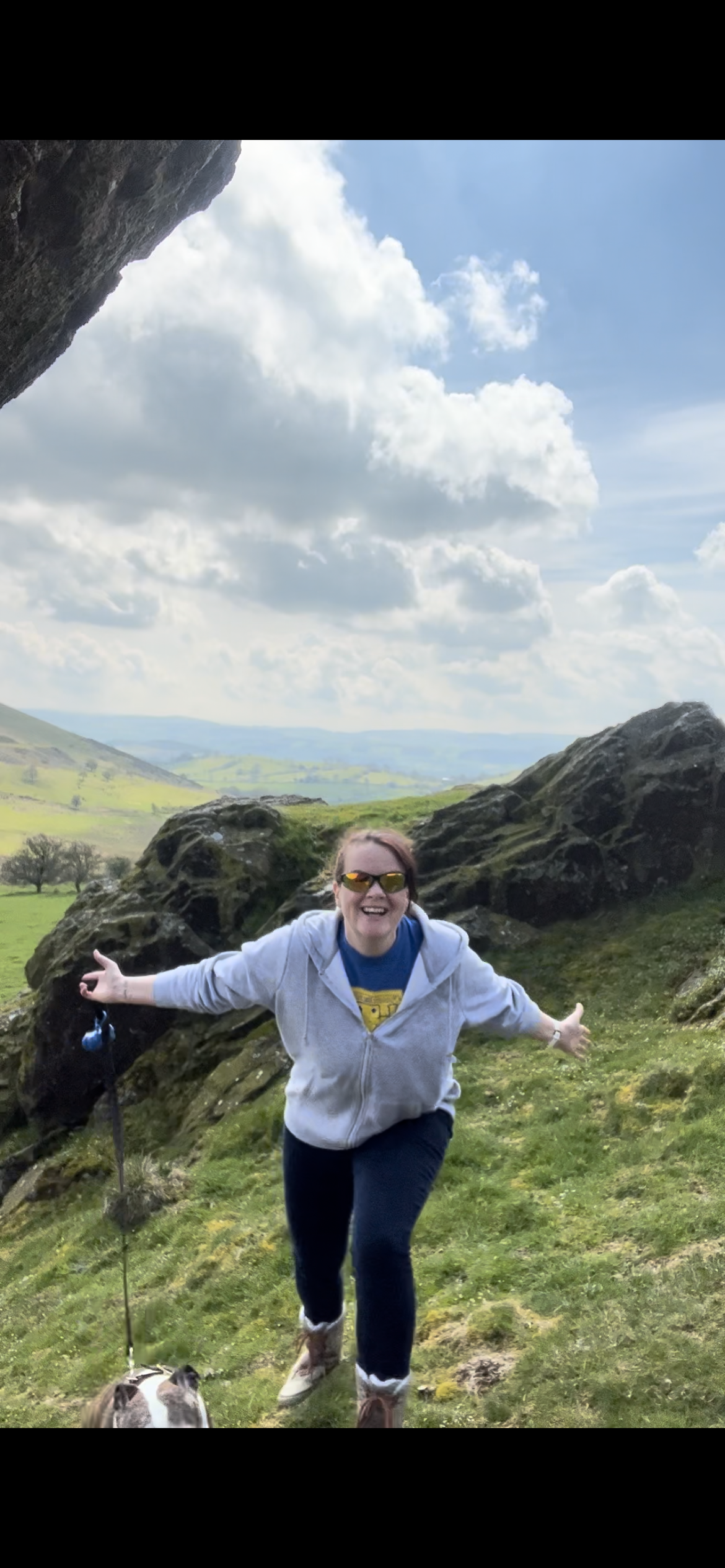 Empowered, liberated woman standing in the mountains