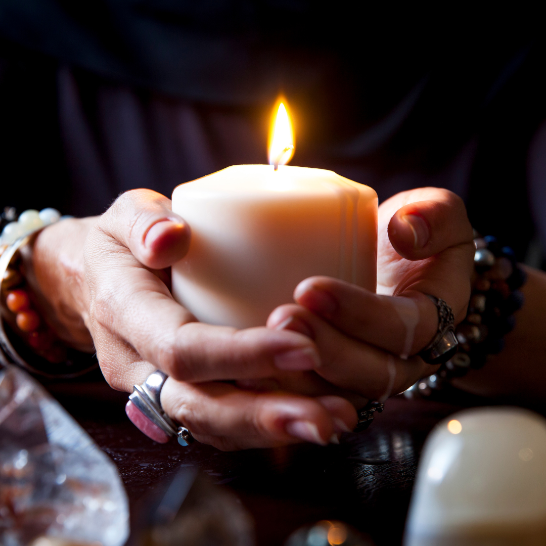 An empowered woman holds a candle, symbolizing inner light, self-help, and spirituality.