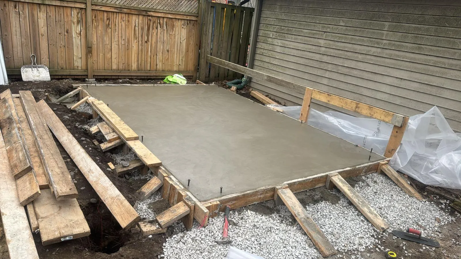 Concrete slab foundation poured for new custom garage build in Toronto by garage construction specialist Concrete slab foundation poured for new custom garage build in Toronto by garage construction specialist